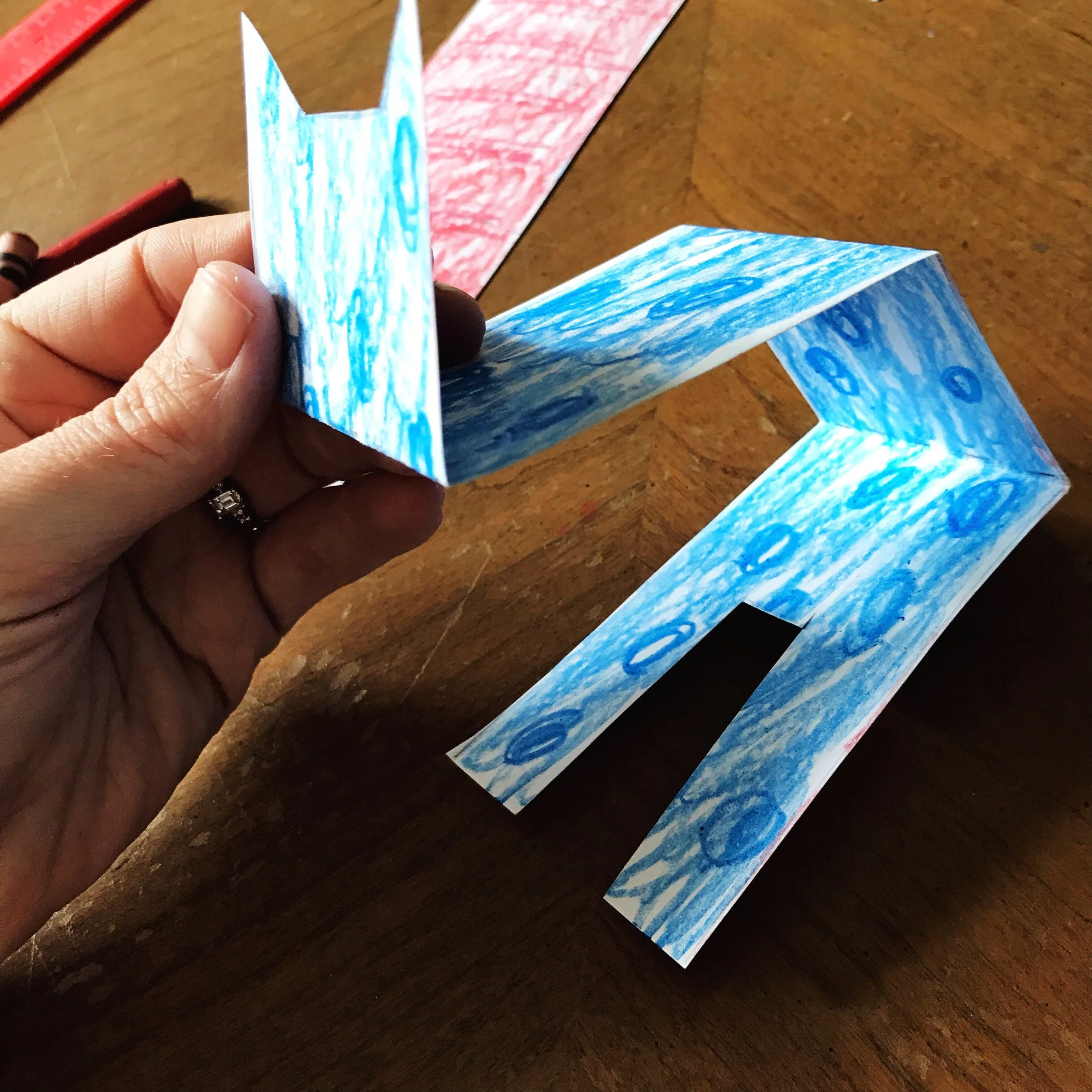 The face folds up one way; the next two folds are down the other way