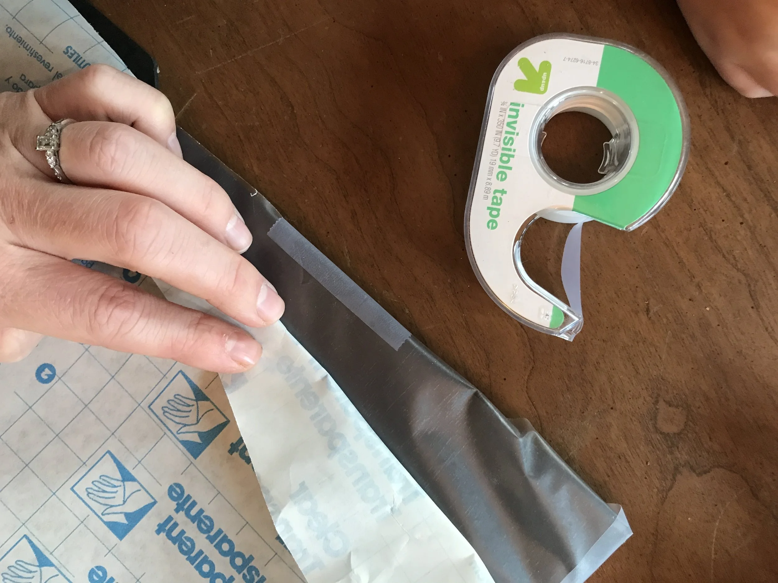 I find it easiest to peel and tape at the same time.