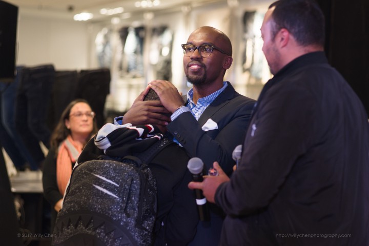 Embracing my younger cousin after a speaking engagement. My cousin David Cook is to the right.