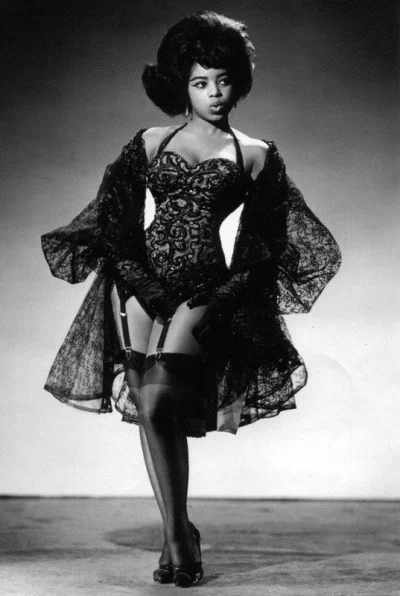 Black and White photograph of Miss Topsy (an African American model) in pin-up.