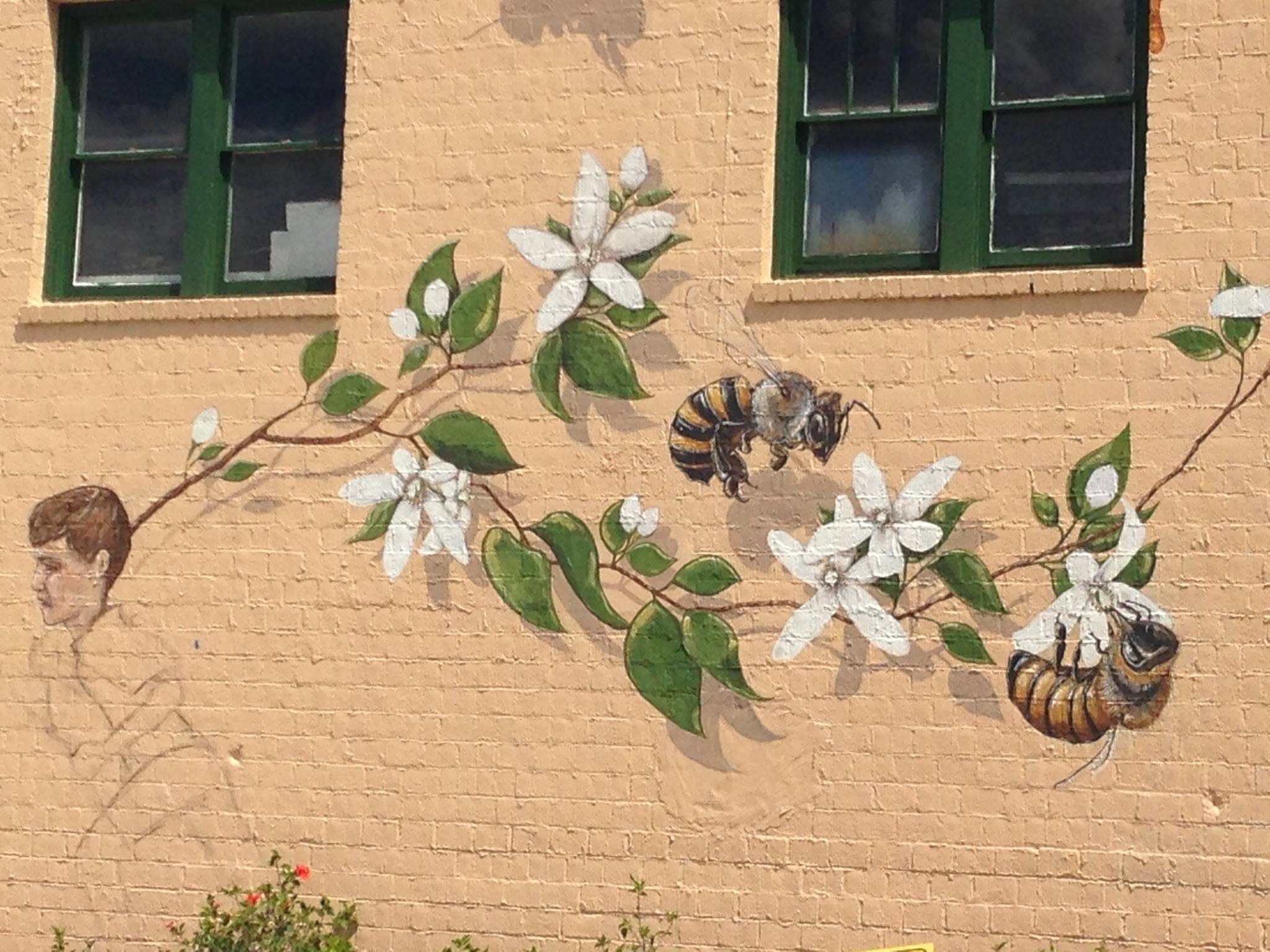 Bees holding onto a branch with flowers