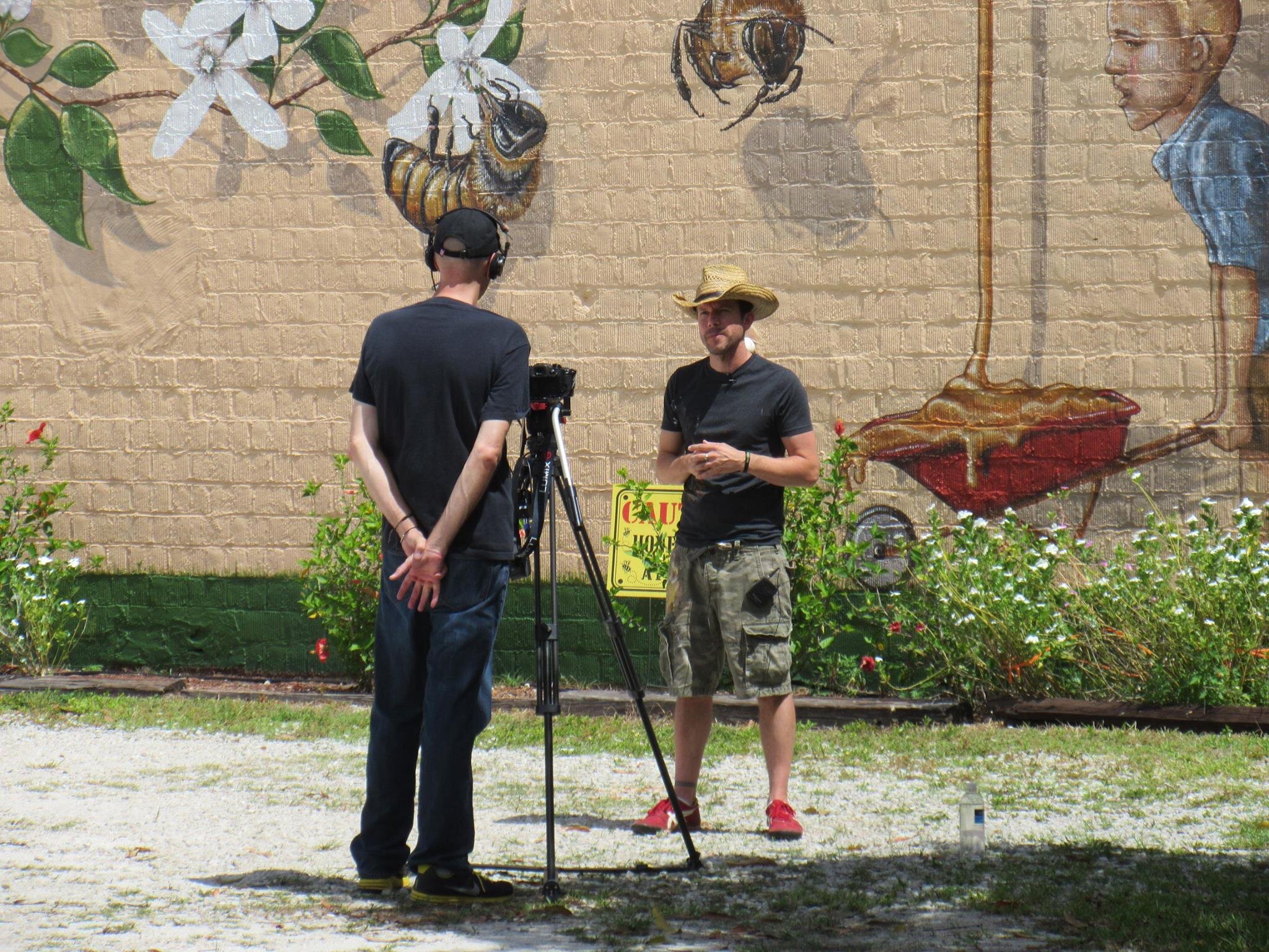 Matt Willey preparing to be photographed in front of the completed mural