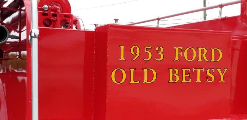 Text on back of fire truck reading "1953 Ford, Old Betsy"