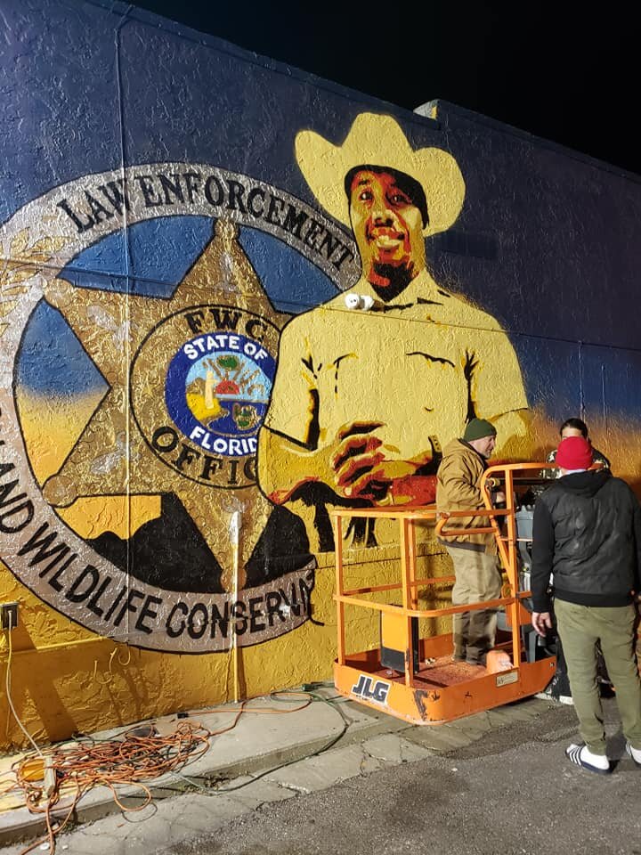 Artists working on the mural