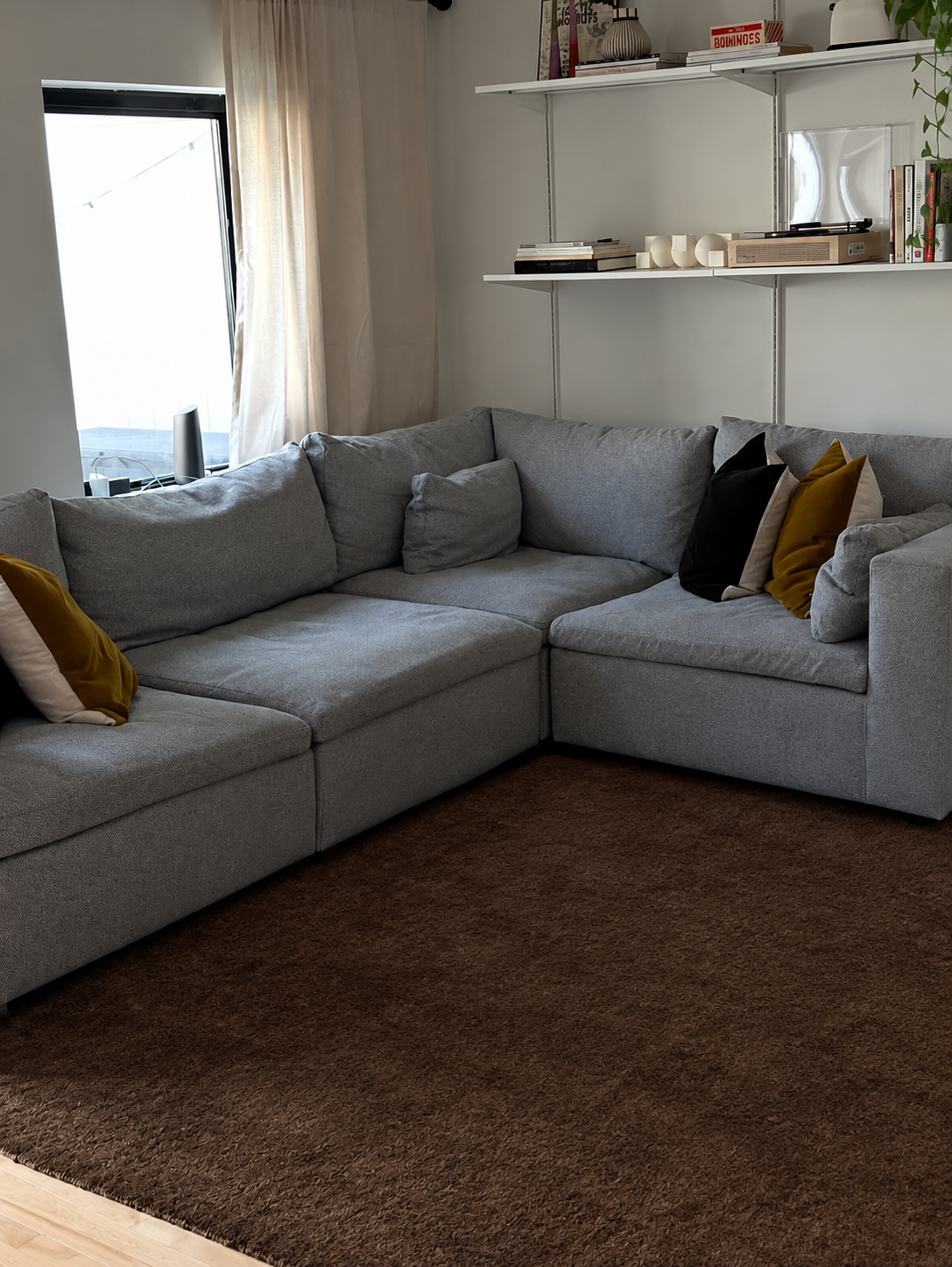 Minimalist Gray Sectional and Open Brown Rug.png