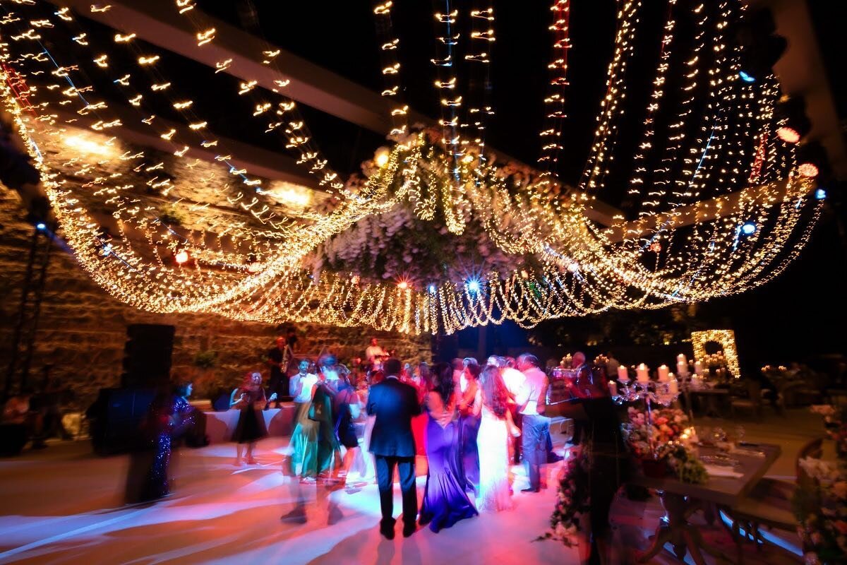 We love how the fairy lights above the dance floor sweep like a low rising chandelier above guests dancing in the beautiful outdoors of a summer wedding in Istanbul. It looks like a cascading strings of jewels. So pretty! 

Wedding planner @ucgluxury