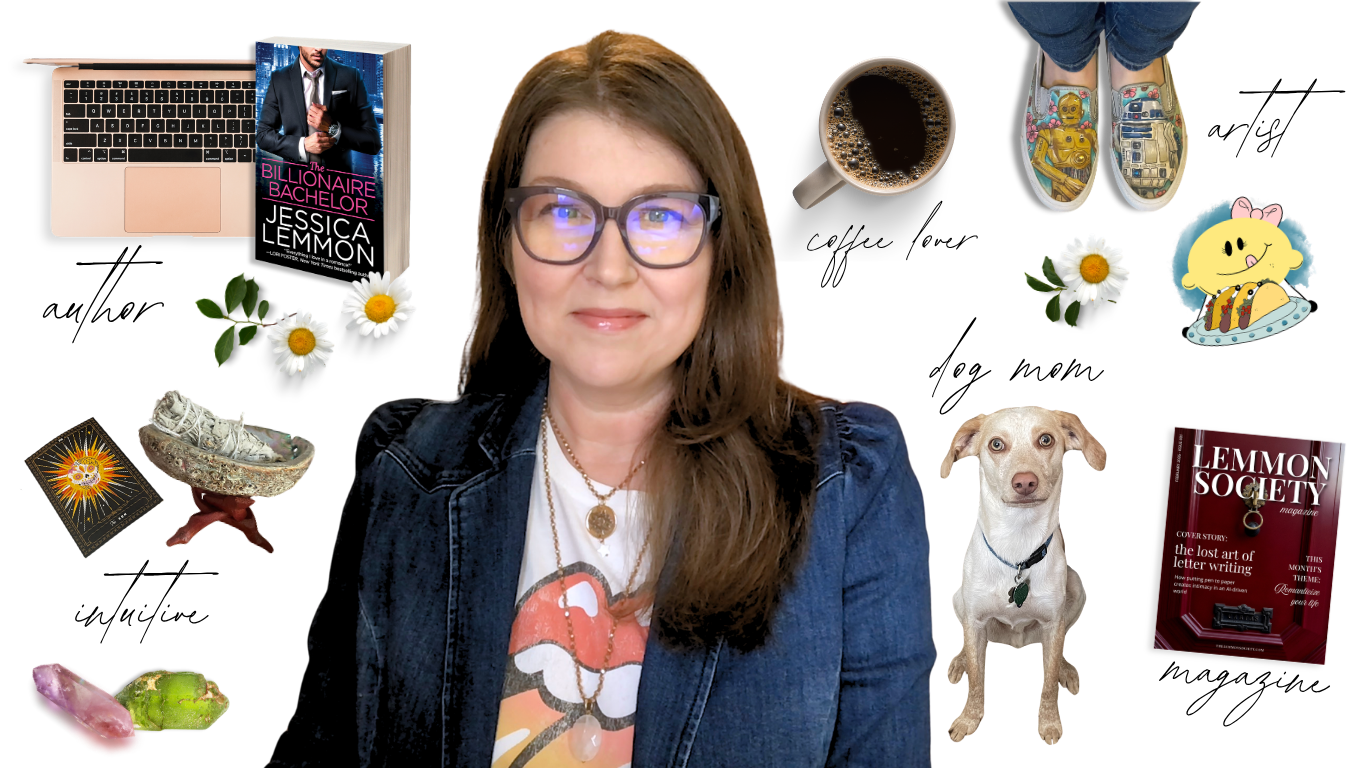 A woman wearing glasses, a denim jacket, and a Rolling Stones t-shirt sits at a desk with various objects around her, including a laptop, a book titled 'The Billionaire Bachelor' by Jessica Lemmon, a coffee mug, comic-style slippers, a cartoon character sticker, a dog, a magazine titled 'Lemmon Society,' flowers, crystals, a tarot card, and jewelry.