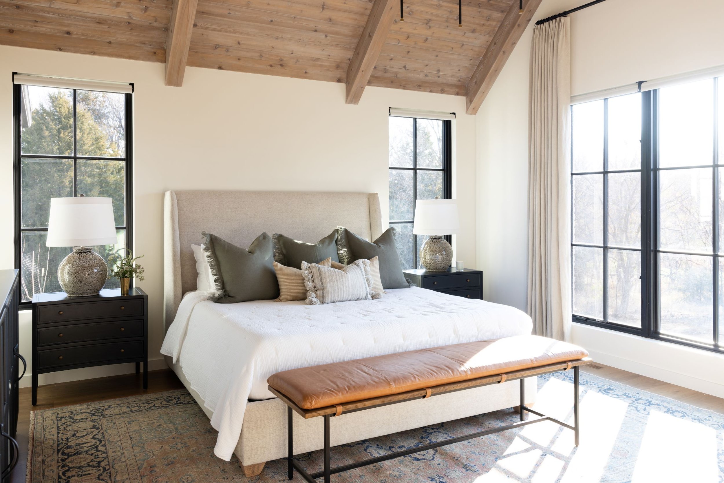 white master bedroom with wood beam ceiling