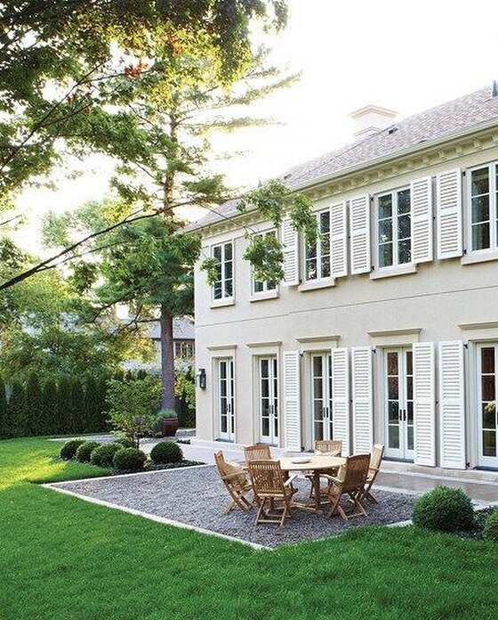 Ahhhh spring time. The weather outside is so lovely. Sunsets are perfection. This photo is brilliance and this outdoor space feels like tranquility. I find it so dreamy with the oversized shutters, the rounded bushes and the natural wood outdoor furn