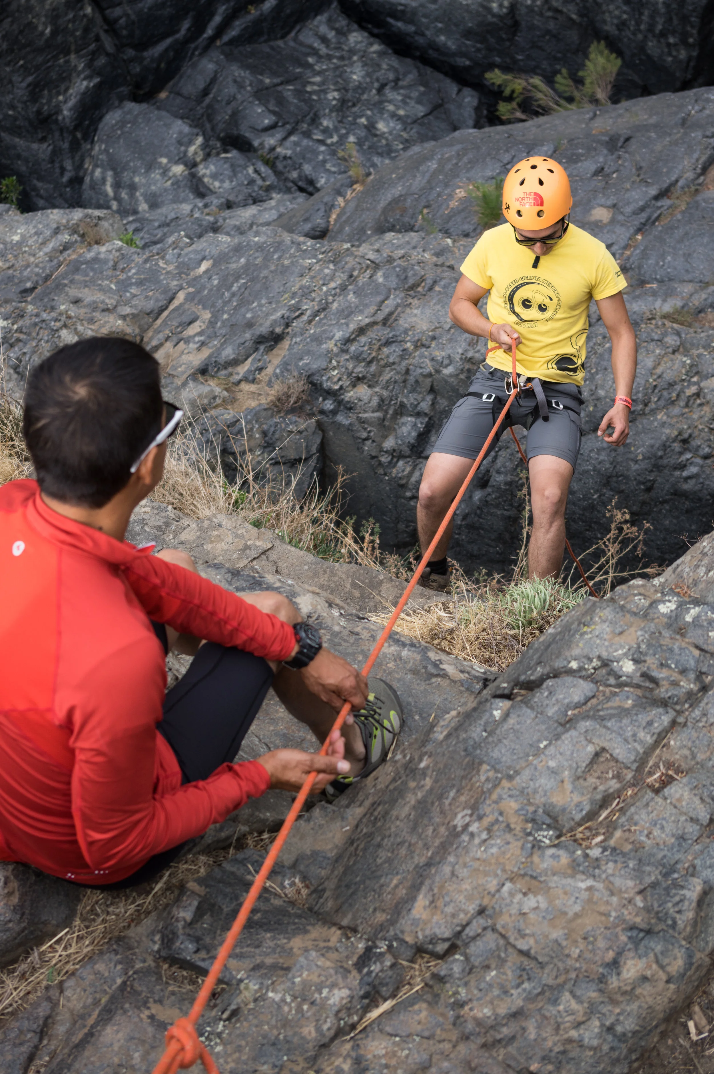Sebastian (right) begins his first descent down a 15 meter wall.