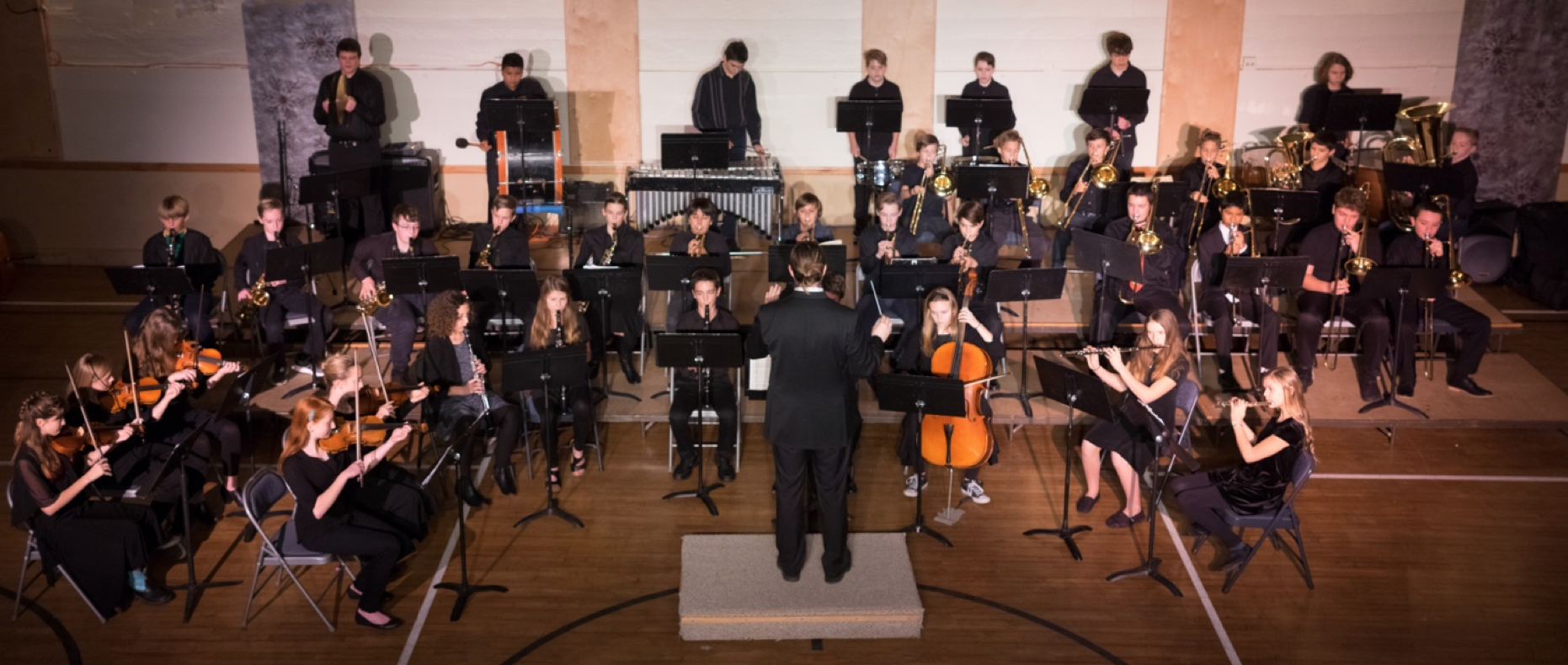 Conductor Matthew Ambrose conducts the 7th-12th graders of Liberty Bell concert band in the piece Dance Macabre.