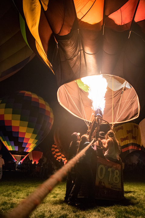 It takes all of David’s friends and family to weight the balloon to prevent lifting off during the Twinkle Twinkle Glow event.