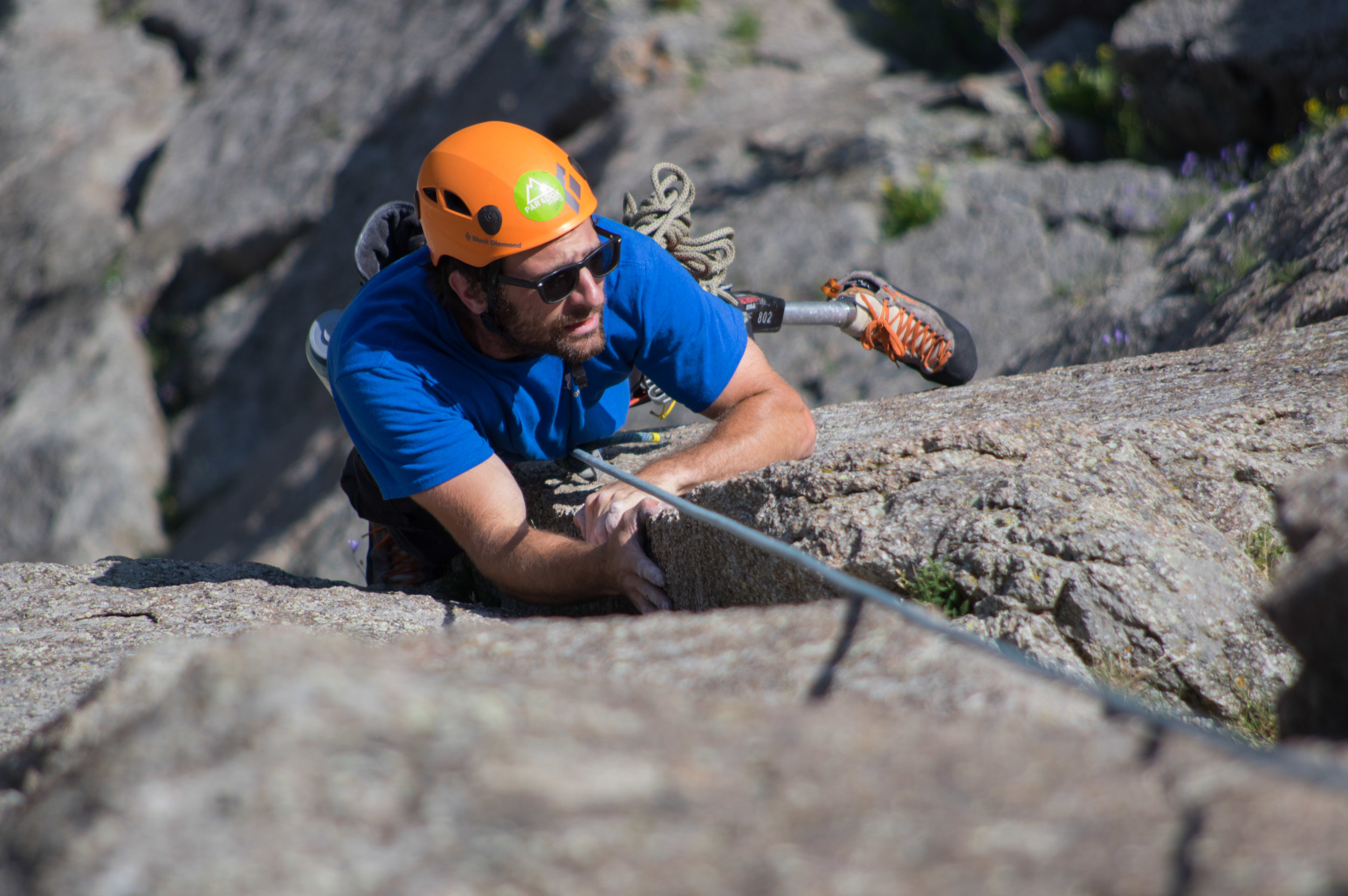The crux move of “New Wave” (5.10a) Dave manages to find a foothold on an almost smooth rock column face.