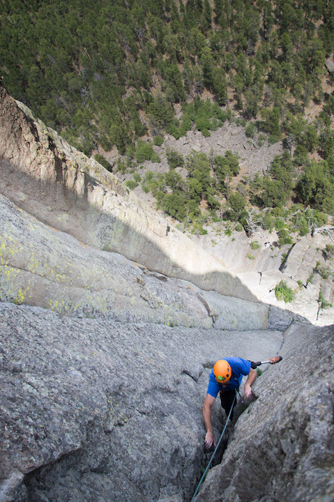 Dave finishes the last few moves of “Assembly Line” (5.9) on the Northeast face of the tower. The route is famous for sustained hand-jams, where the climber wedges his whole hand and foot in the crack and advances upwards.