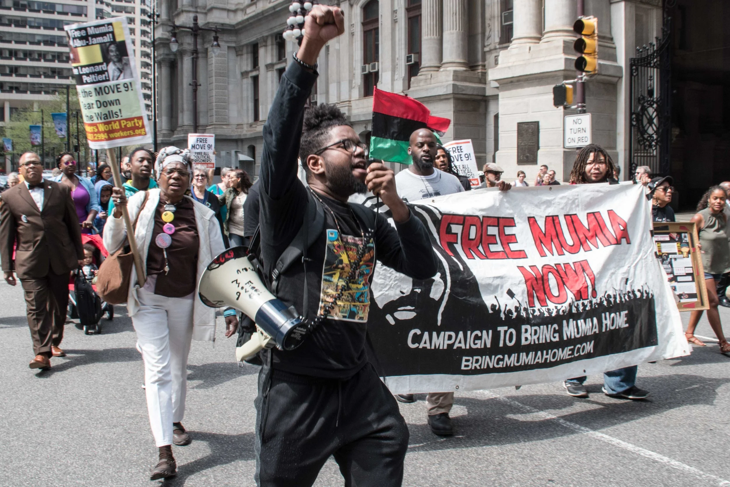 Philadelphia, Apr 18, 2019 - Press Conference for Mumia Abu-Jamal. REAL Justice member Ant Smith leading march from Octavius Catto statue at City Hall to District Attorneys office. (photo credit: Joe Piette)