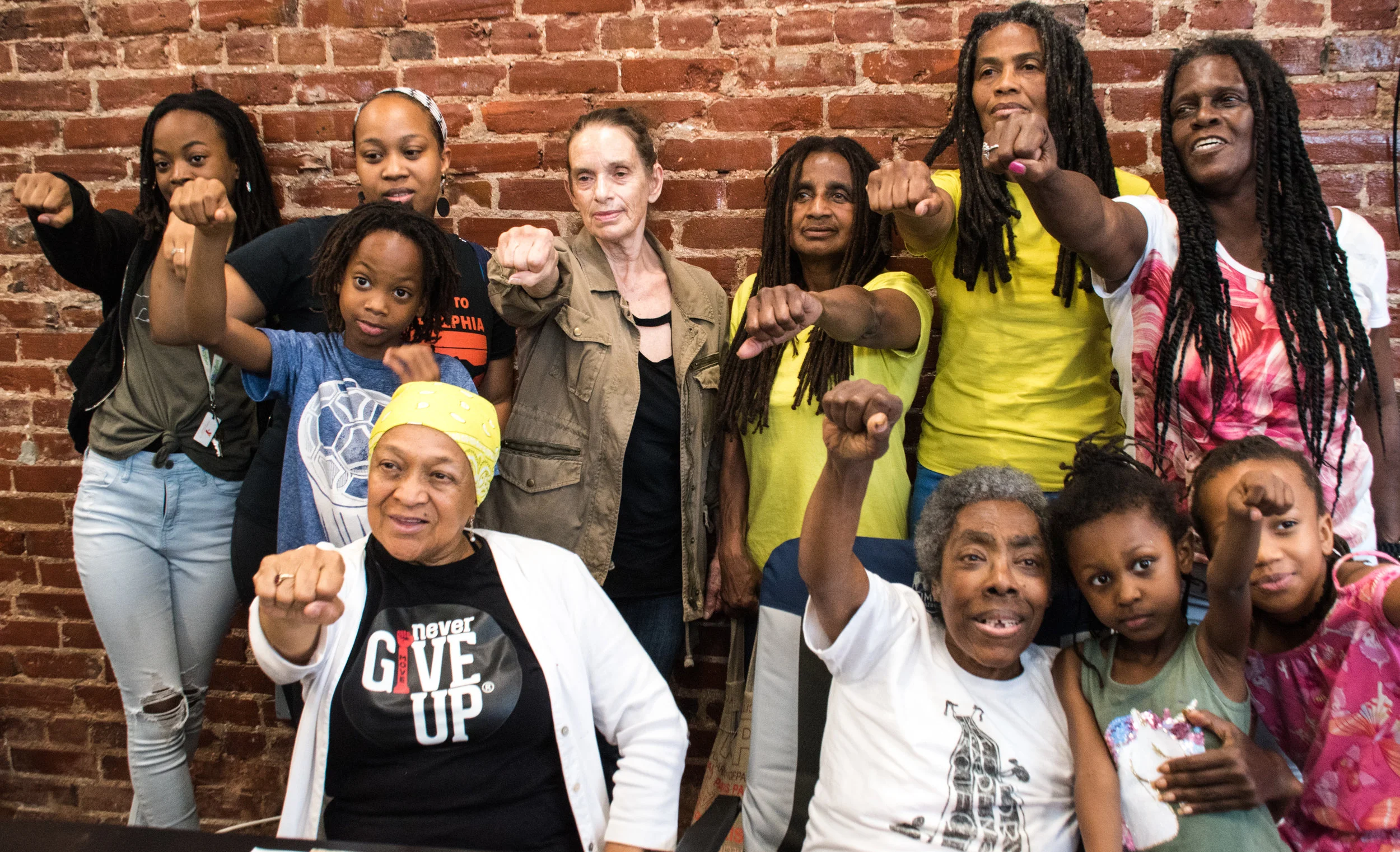 Newly released MOVE 9 members Janet and Janine Africa (in yellow shirts, L to R) with other MOVE members after May 30 press conference in Philadelphia. Photo; Joe Piette