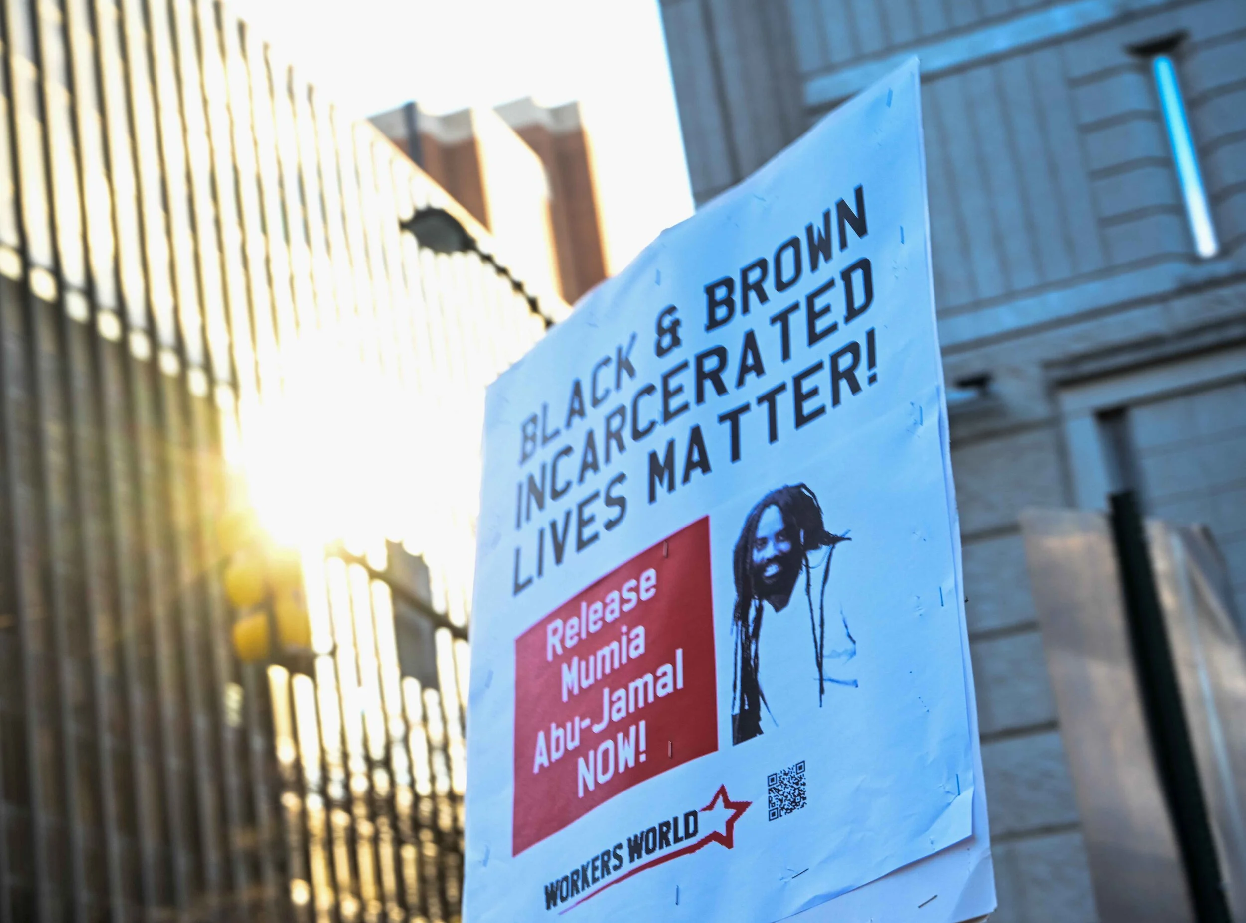 Prisons are concentration camps for the poor-- during COVID, they are death camps for the poor. On Saturday, November 28 at 2pm at the Federal Detention Center at 7th and Arch streets demonstrators showed solidarity with Russell Maroon Shoatz, Mumia Abu-Jamal and all those on the inside and to demand their release, no matter if they're incarcerated in city jails, state prisons or federal detention centers.  In less than a month there have been at least 200 new COVID cases in the Philly FDC.  Attorneys of three people incarcerated at the FDC have filed a lawsuit against the facility claiming they have failed to implement COVID protections. Additionally, corrections officers at the FDC have filed OSHA complaints alleging the same failings. Without adequate sanitation, social distancing or PPE, inmates at the FDC are not able to protect themselves from this virus even if they tried. A public health crisis turns genocidal in these conditions.  On top of these conditions, the lockdown measures introduced in response to the outbreak have compounded the already crushing isolation of prison. Inmates are only being allowed out of their cells three times a week for 30 minutes and all family, friend and attorney visits are suspended. Families and friends of inmates in the FDC have in some cases gone weeks without any contact at all.   Community activists let those on the inside know they are not alone in their fight. Throughout the protest, we could hear the clicking sounds from prisoners hitting the narrow windows with objects to let us know they heard us.  Prisons across Pennsylvania and the U.S. are facing a deadly full-blown resurgence of COVID-19 among those incarcerated as well as staff. The result has been outbreaks of COVID-19 in 21 of the 23 PA prisons.  Russell Maroon Shoatz, who is 77 years old and has been incarcerated since 1972, and other elderly prisoners with Covid are being held in inhumane and unsanitary conditions. He poses no threat to the community. He has stage 4 colon cancer and on November 11th, tested positive for COVID-19. Maroon was then held for 10 days in a gymnasium with 30 other COVID-19 positive inmates who all shared one bathroom toilet, until he was finally moved to the infirmary after advocacy from family and supporters. He is being denied an urgent surgery to aid his colon cancer and needs immediate medical care.  As of Nov. 12, there have been 17 reported deaths of incarcerated people in the PA DOC. At least 442 prisoners and 244 staff have tested positive. According to the Department of Corrections, when staff have requested testing, more than half are positive for the coronavirus. Testing of staff is not mandatory.  Rather than release more people or make staff testing mandatory, PADOC officials have responded by moving prisoners who test positive to other prisons or isolation units within a prison. The lockdown policies have been kept in place for over seven months now, amounting to mass torture for the over 46,000 incarcerated workers.  Free them all!  More photos  here .