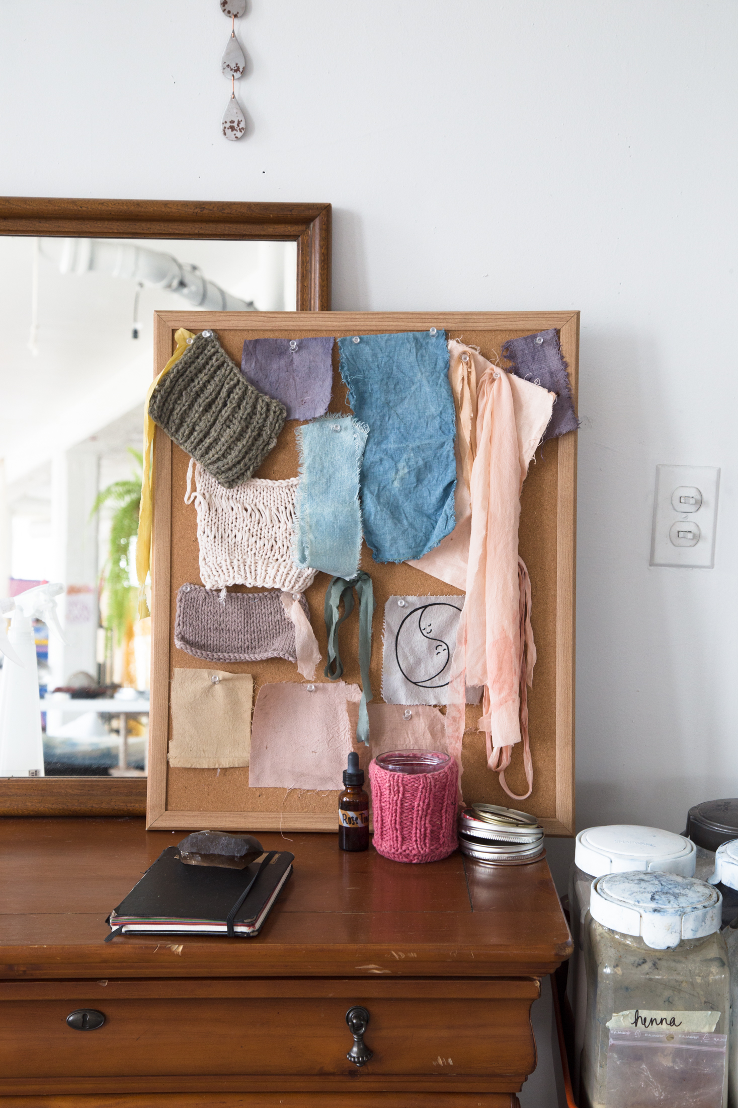 corkboard of swatches, knitted and dyed // a rose tincture from a friend, smoky quartz from Eldorado General Store in Corktown, yin yang patch by Eliza Fernand