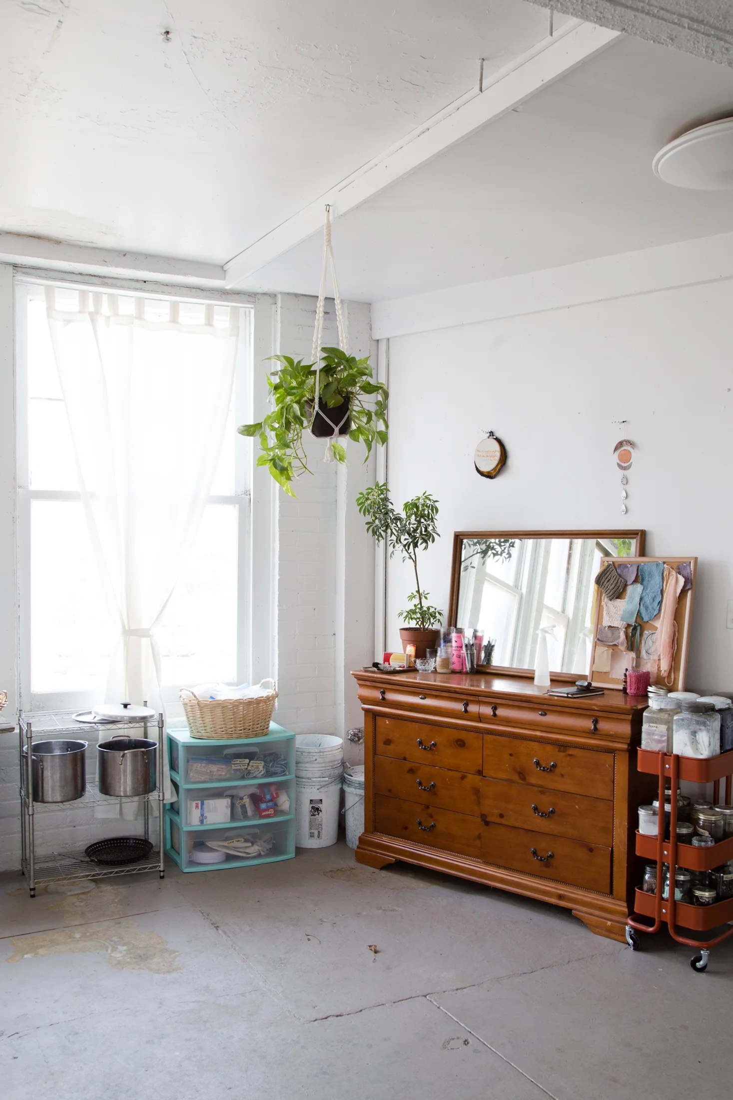 a macrame plant hanger my mom made in the 70s, a cart filled with jars of dye materials, lots of pots for dyeing. 