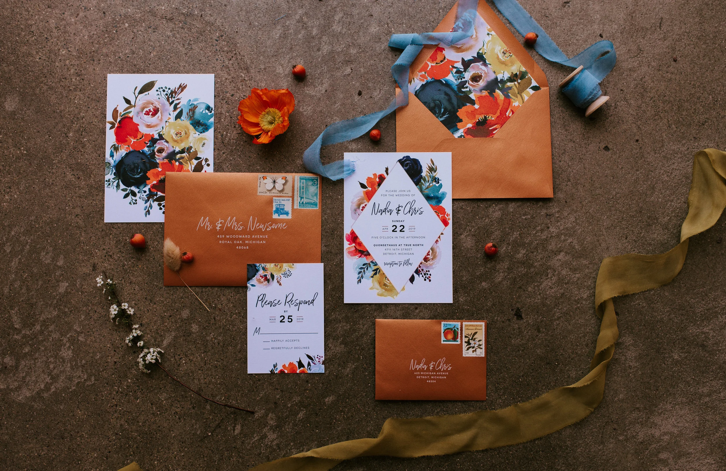 A flat lay featuring watercolor invitations designed by Invitations By Caitlin . Shown here is Rosemarine Textiles 2" wide deep chartreuse silk ribbon in chiffon and 1" wide light indigo ribbon in chiffon.