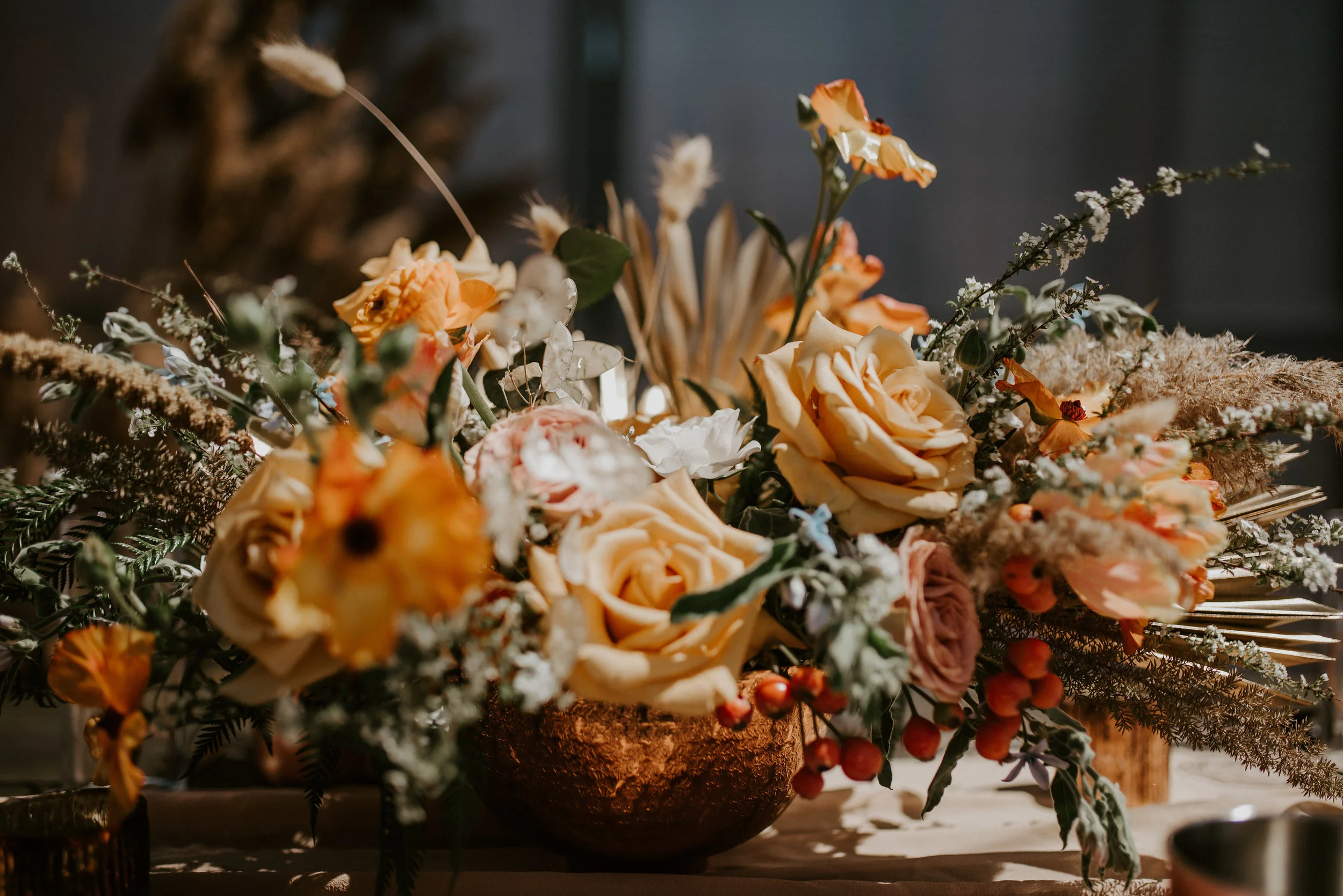 Beautiful and expansive peach toned floral centerpiece by Studio Terrain.