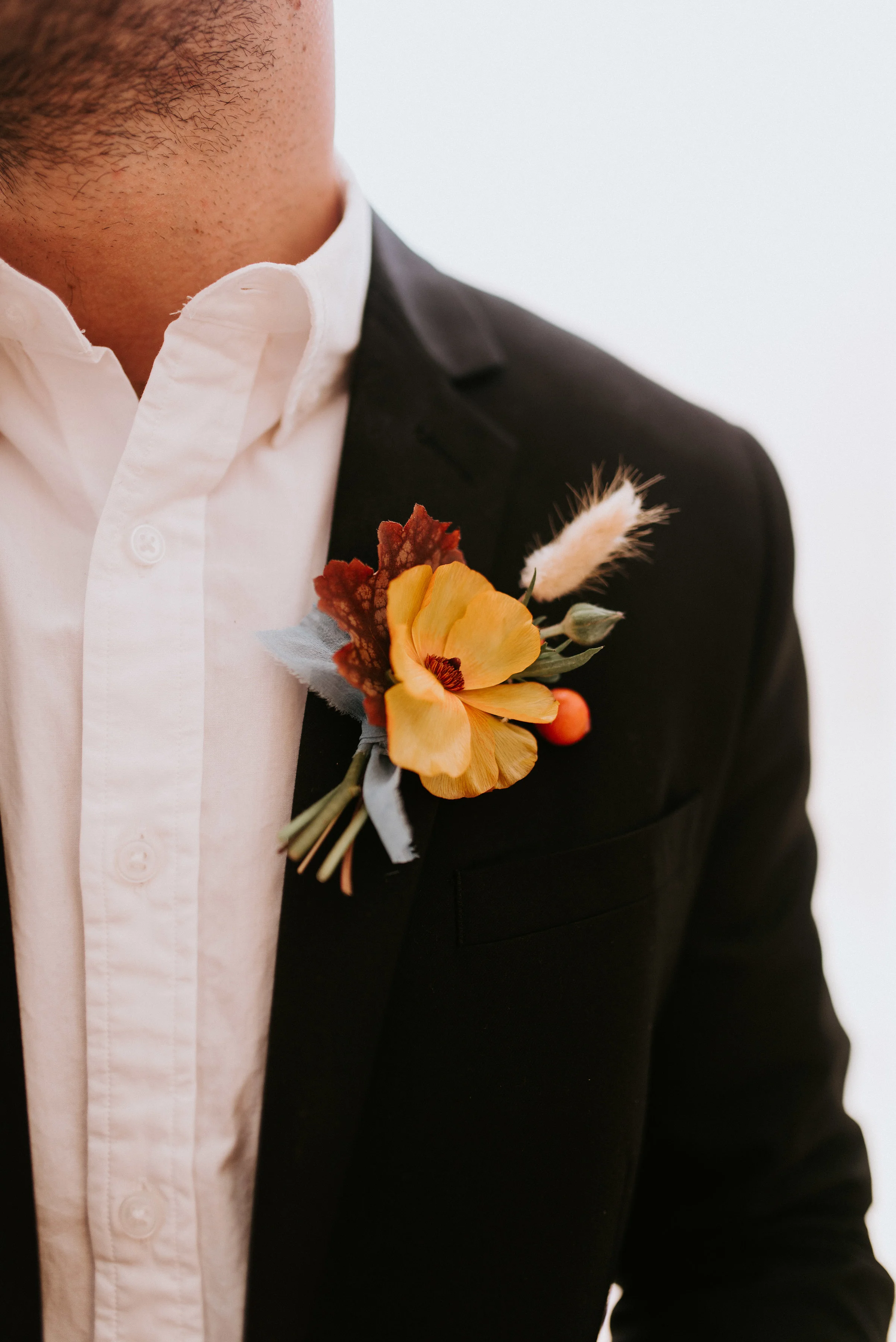 A sweet little textural boutonniere featuring a 1" wide light indigo chiffon ribbon.