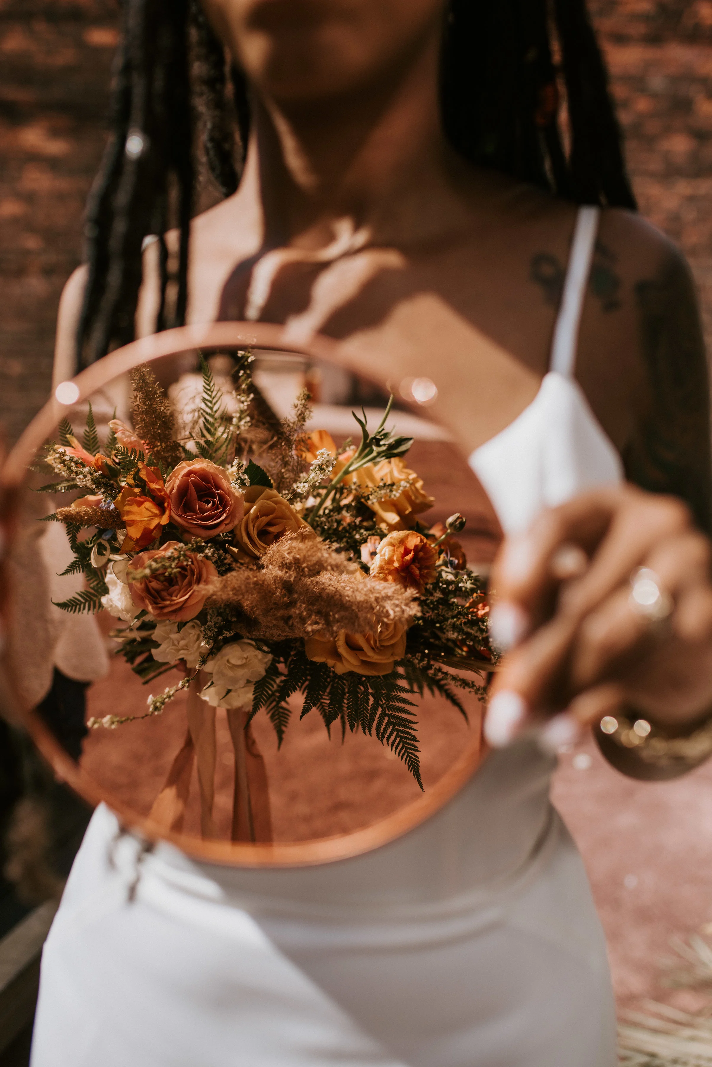 l love this beautiful and creative shot of the bouquet by Northern Native Photography. The warm autumnal tones of the flowers Fatima of Studio Terrain designed went so well with Rosemarine Textiles 2" wide rust chiffon and 2" wide sand habotai silk ribbons.