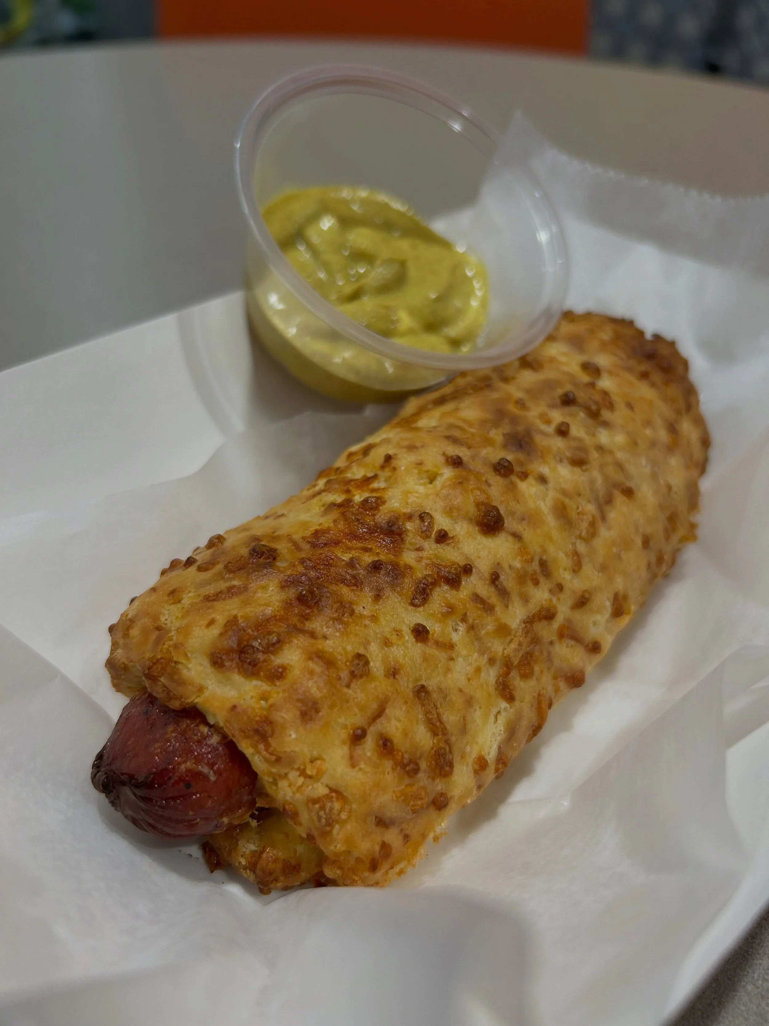 Introducing spicy sausage wrapped in our signature cheddar biscuit! Have it with a side of mustard for dipping. Perfect for a quick bite or snack!