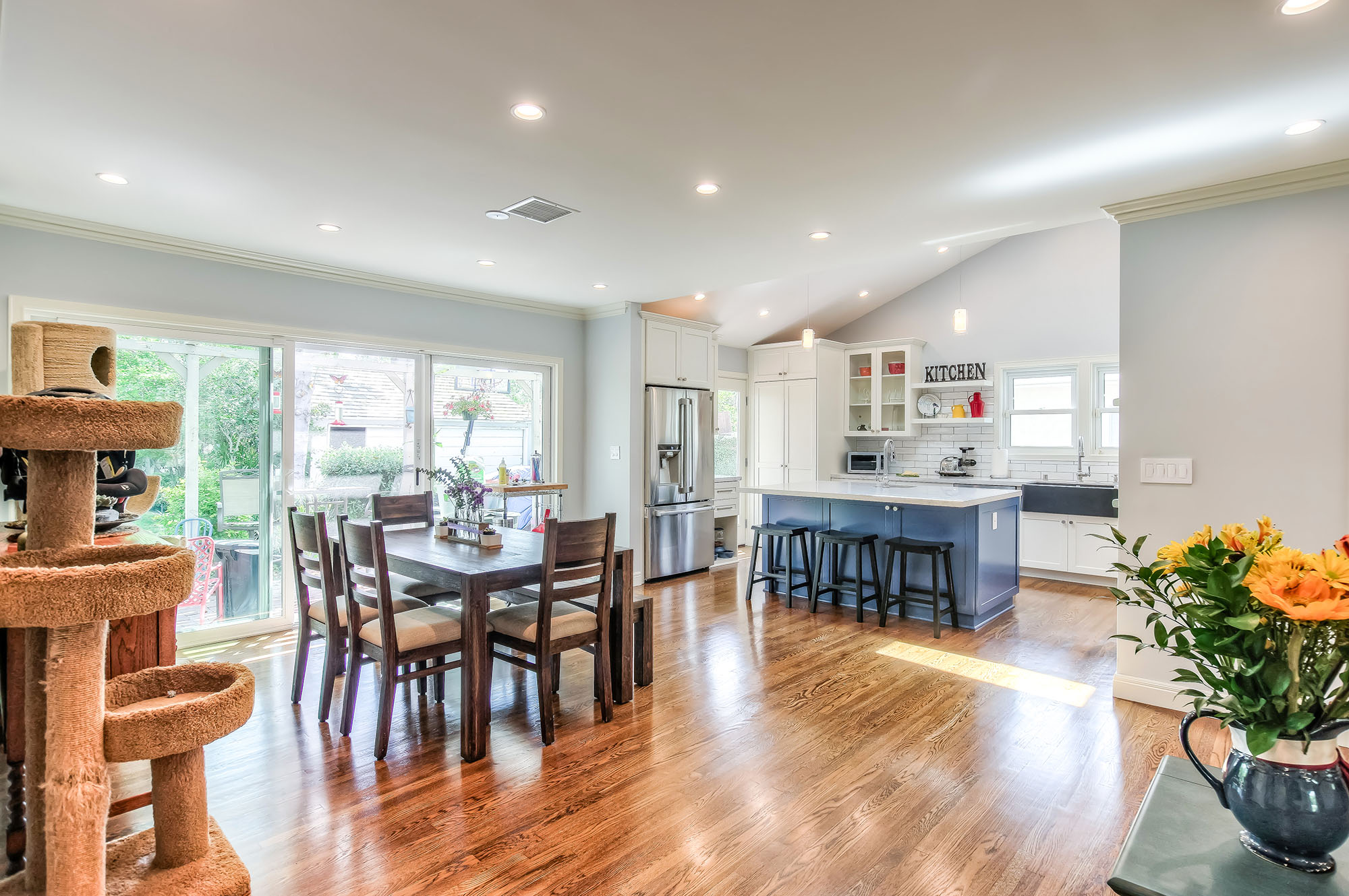  The small and boxed kitchen and dining room were combined with an open floor plan and include raised vaulted ceilings and skylights in the kitchen area to create a roomy and airy space. 