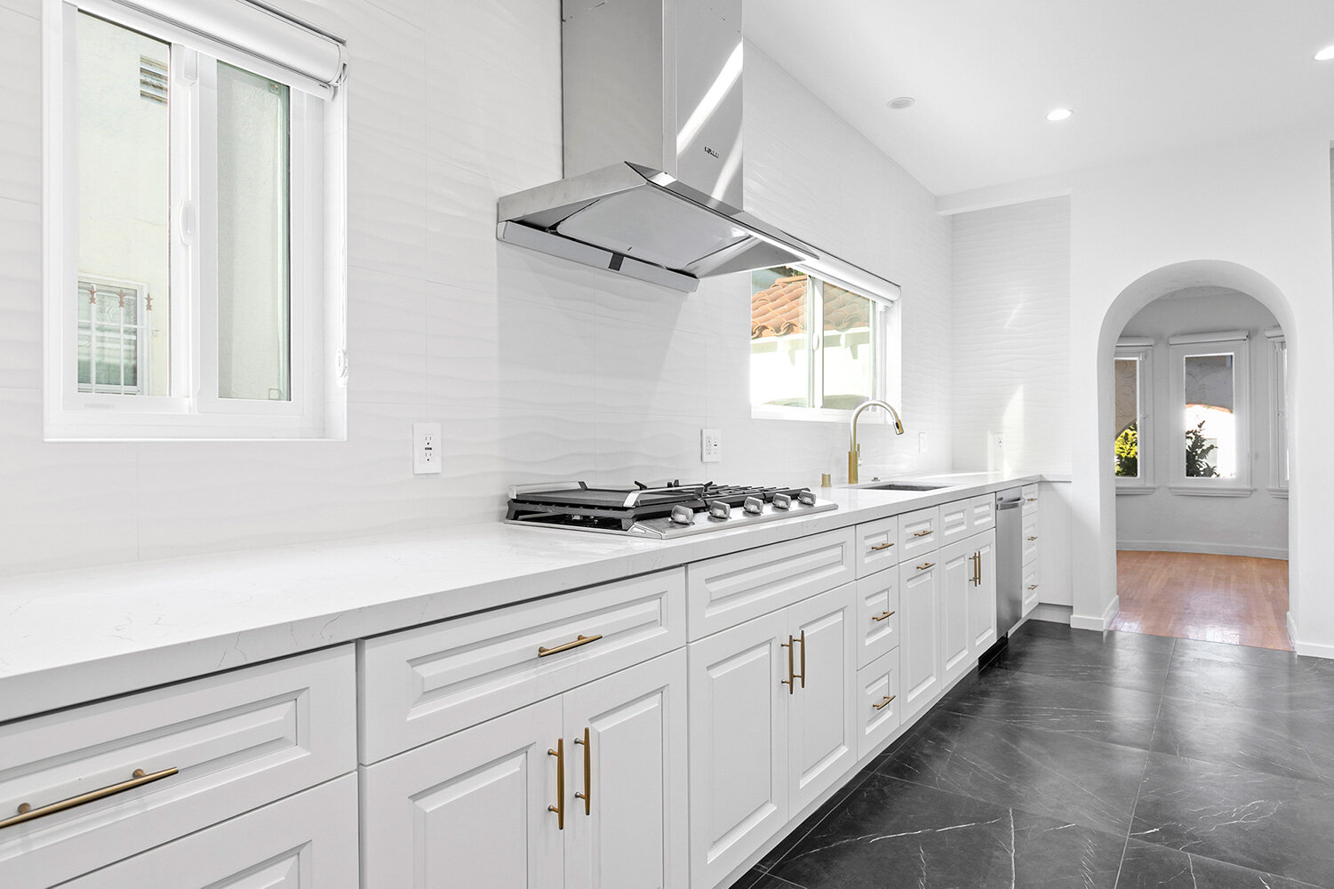 Spazio LA Kitchen remodel - white shaker cabinets - white wave backsplash.jpg