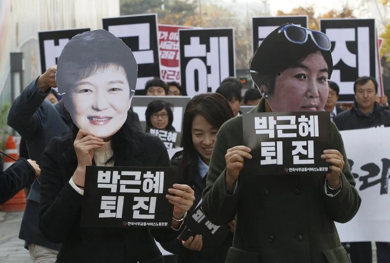 Protestors donned masks depicting President Park Geun-Hye and Choon Soonsil