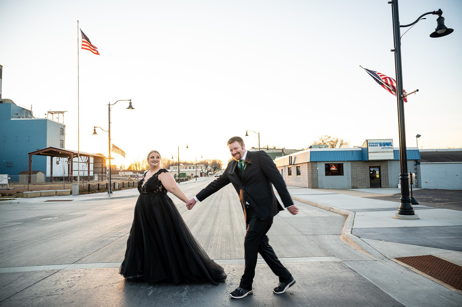 Fun outdoor photo of bride and groom bride is in stunning black gown Twin Birch Studio