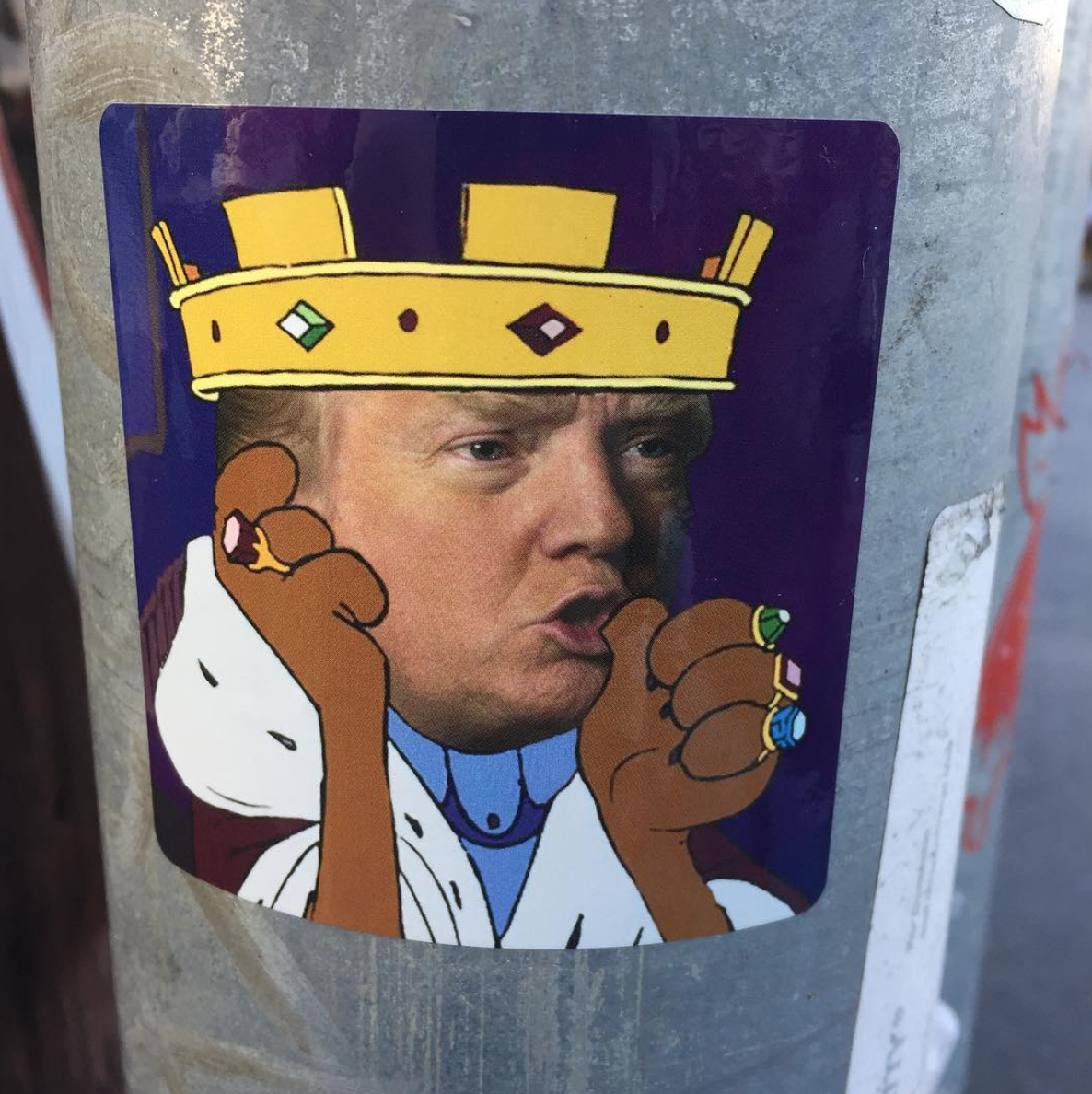 Picture of Trump sucking his thumb with a crown on.