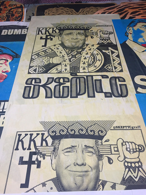 Picture of Trump as a playing card King that says "Skeptic" and with the KKK in the background
