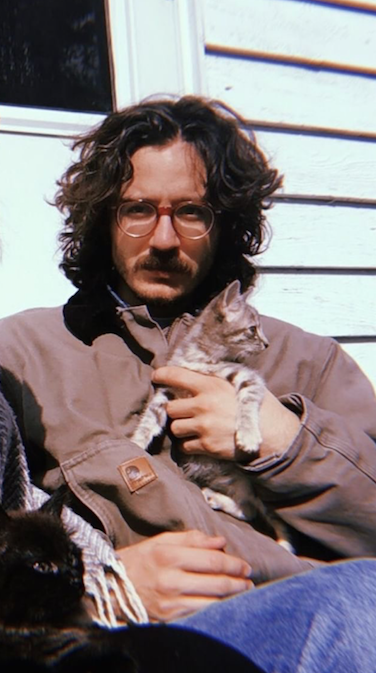 Joey and his kitties. He’s holding Tammy Wynette. The lil one in the corner is Possum.