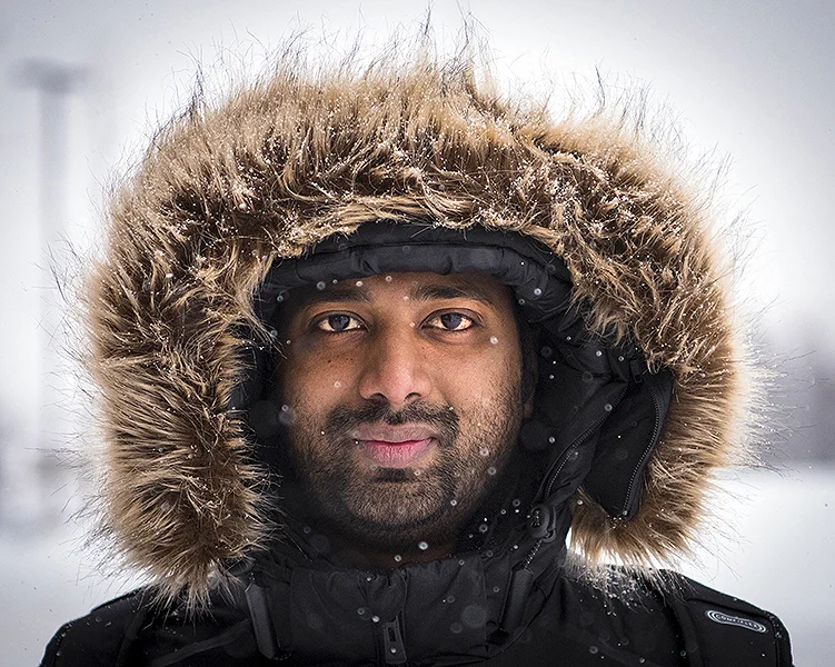 Joseph Philiph, a Niagara College Student, poses for a photo during an oncoming snowstorm. Crews worked overtime around the campus to clear the snow.