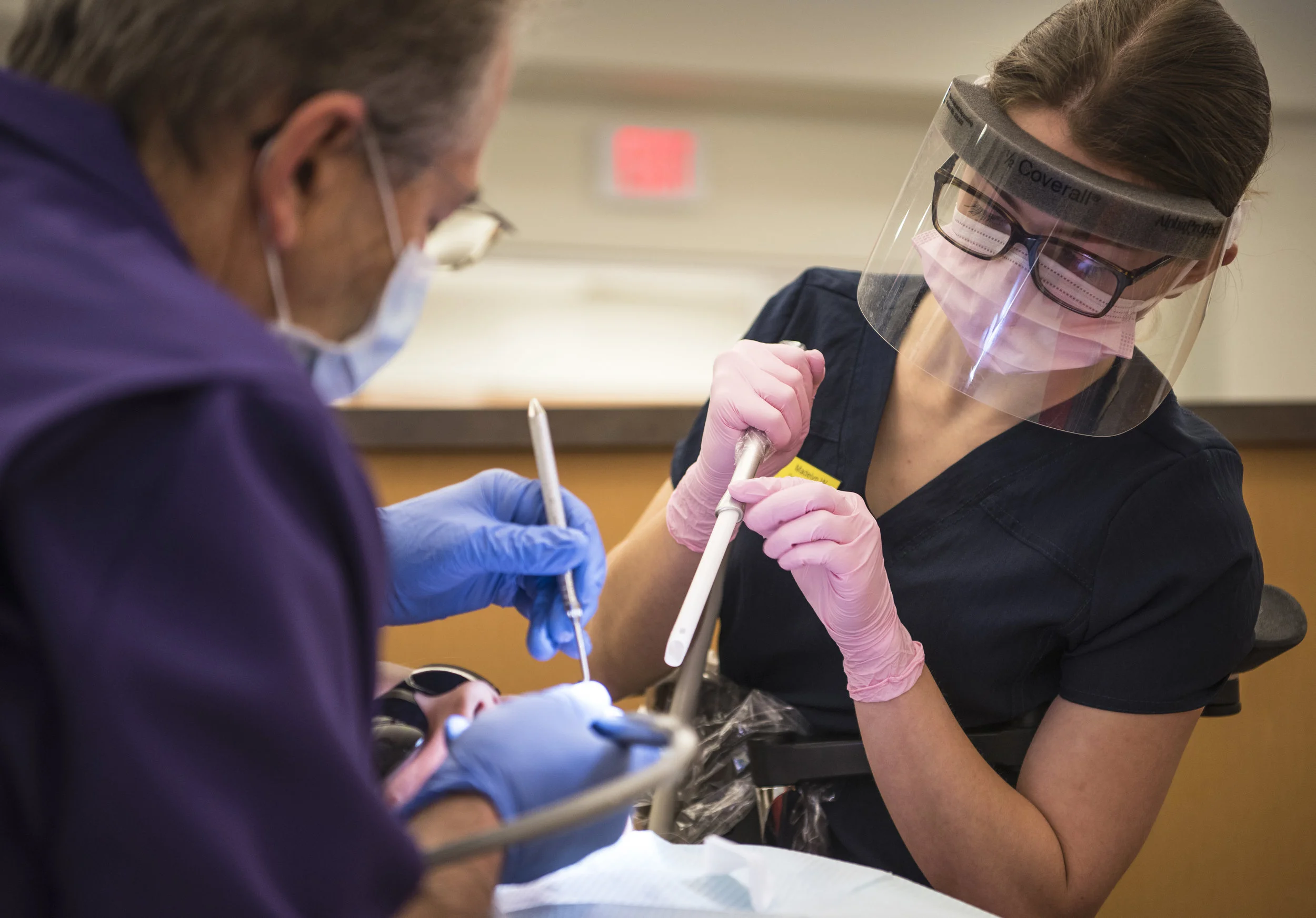 Dr. Fred Ross and dental assistant student Maddie Wright clean the teeth of a Welland elementary school student at the Niagara College dental clinic on Friday during the Shiny Smiles program. 