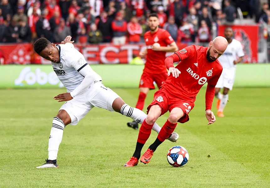 May 11, 2019: Philadelphia Union forward Sergio Santos (17) tackles Toronto FC defender Laurent Ciman (26) at BMO Field in Toronto, Ontario. Philadelphia defeated Toronto 2-1.