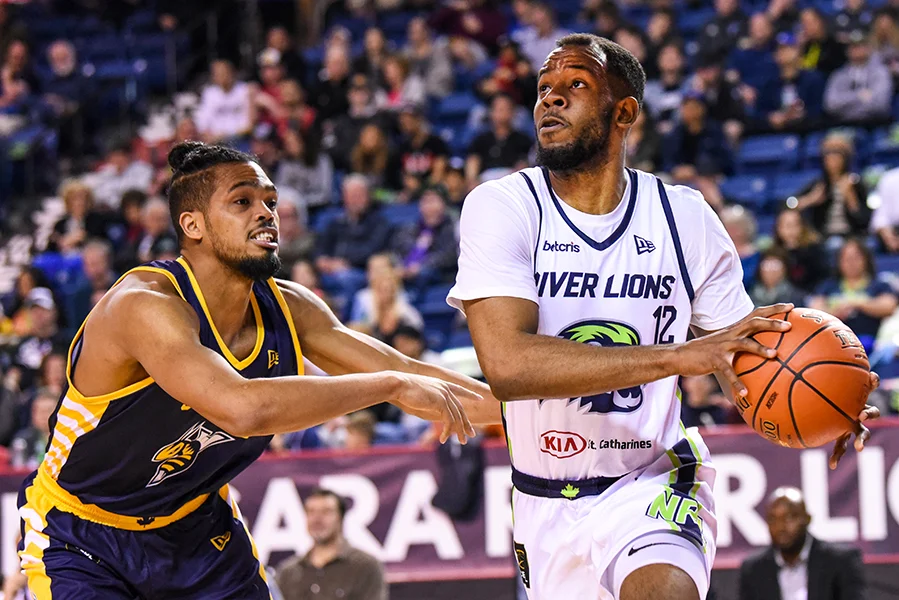 Niagara River Lions forward Yohanny Dalembert (12) is guarded by Edmonton Stingers forward Will Davis II (33), during CEBL action at St. Catharines' Meridian Centre on May 16. The River Lions won the game by a score of 108-66.