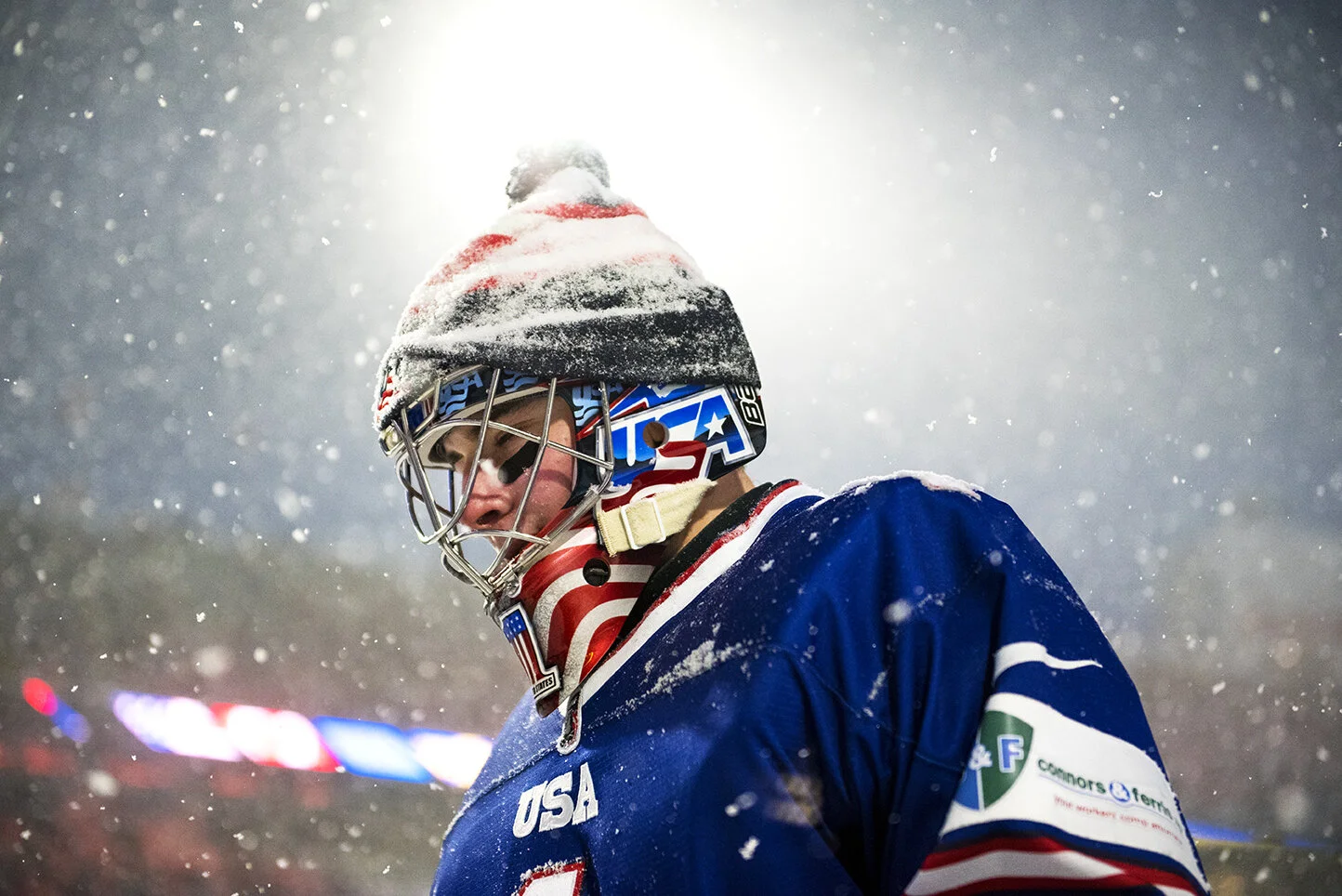 United States goaltender Jeremy Swayman is illuminated by the bright lights at Orchard Park, NY’s New Era Field during the 2018 IIHF World Junior Championship’s outdoor game.