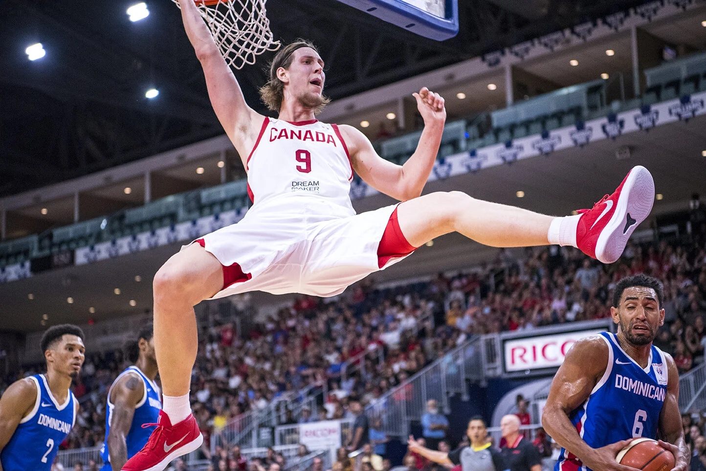 Team Canada player Kelly Olynyk reacts following a dunk at a FIBA Basketball World Cup qualifier against the Dominican Republic.