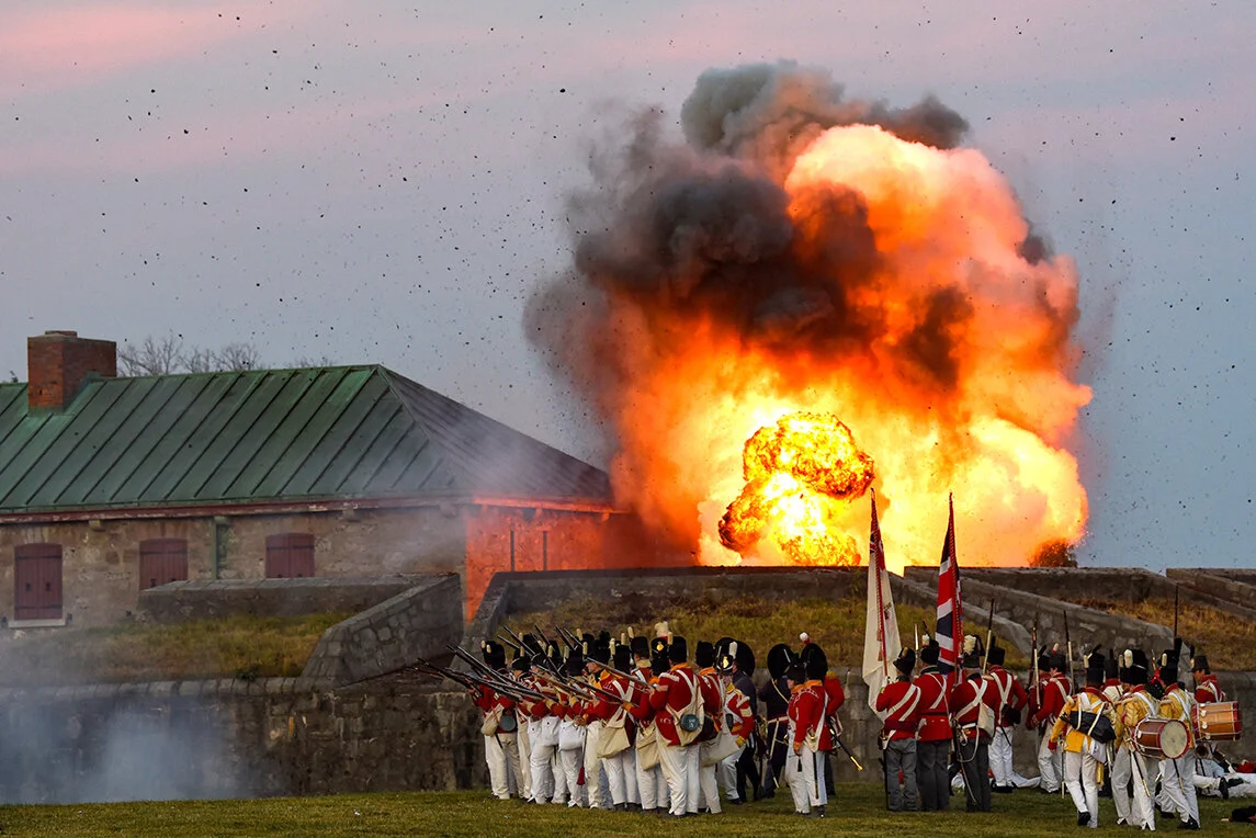 An explosion rises above Old Fort Erie during a battle re-enactment in Fort Erie, Ont.