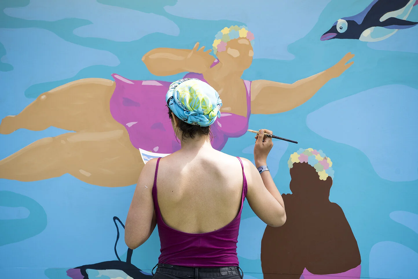Muralist Tisha Myles blends in with her work at Field Trip Music Festival in Toronto, Ont.
