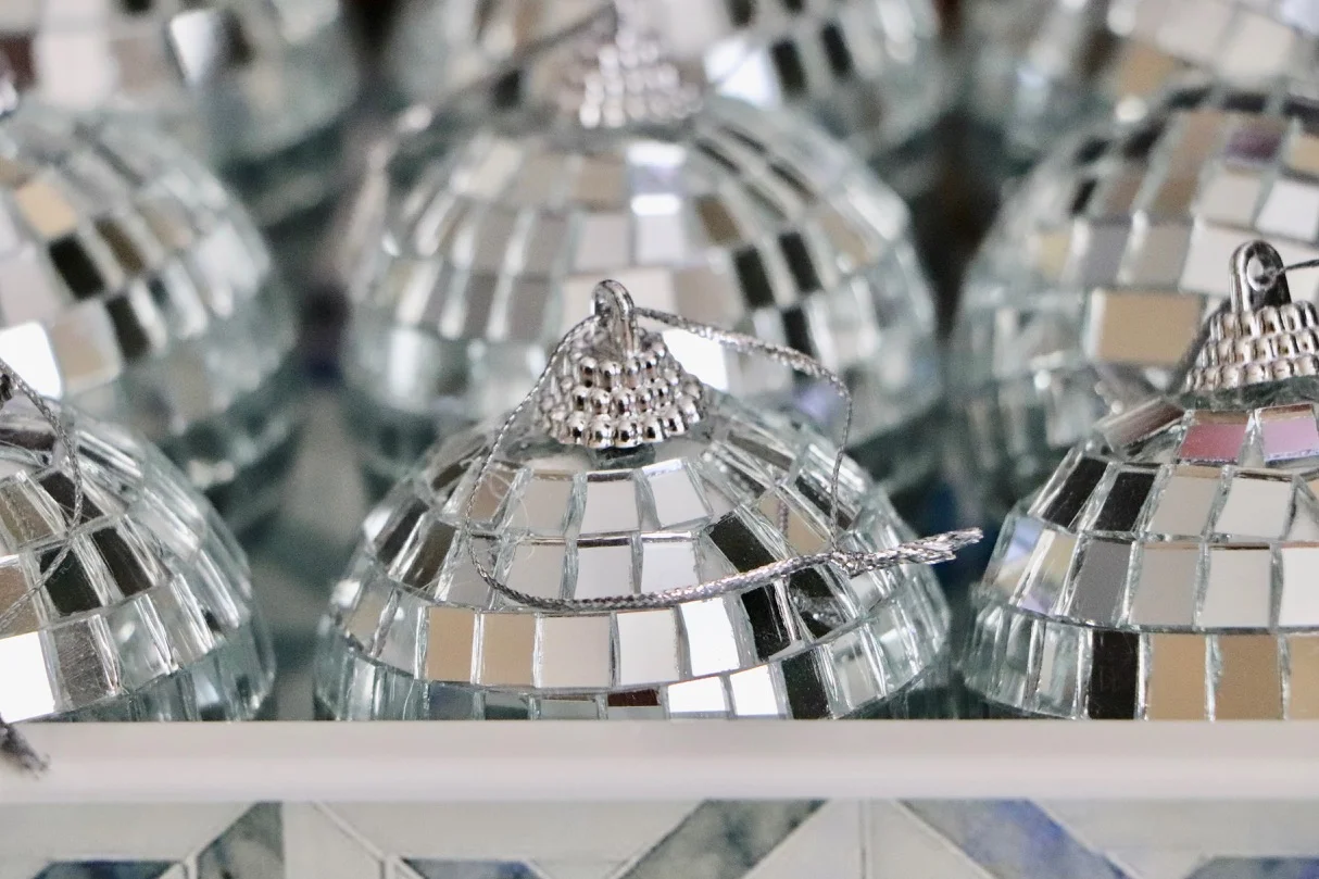 Mirror ball ornaments are a MUST on my Christmas tree! I like to put these on the side of the tree facing the window so that they sparkle in the sunlight during the day! Photo by: Lighter Side Interiors