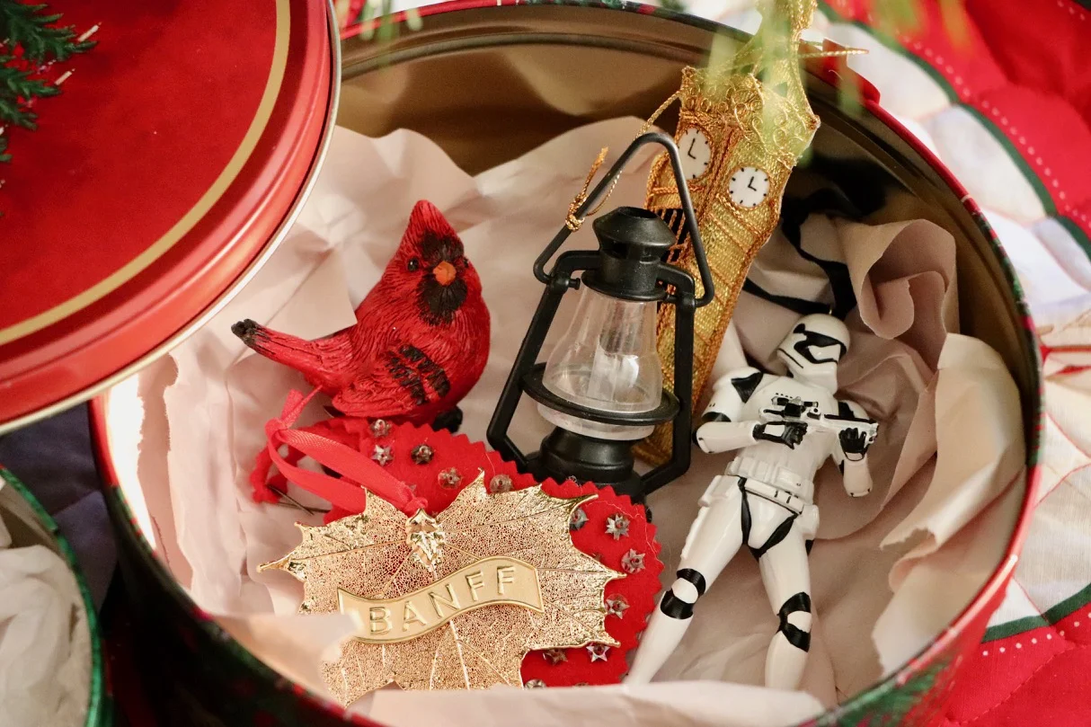 A cookie tin and some newsprint paper is all you need to store those ornaments for next year! Photo by: Lighter Side Interiors