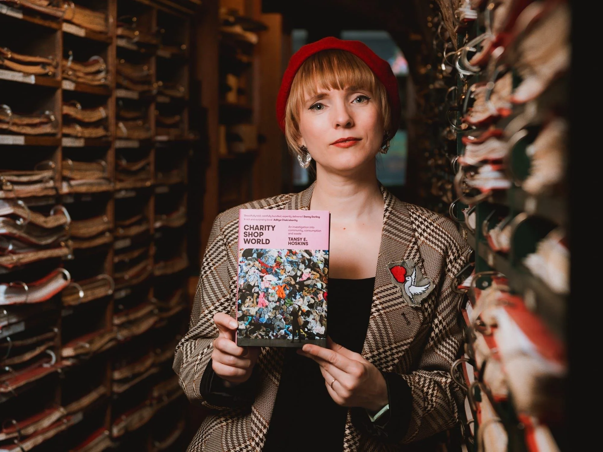 Author Tansy Hopkins holding her book Charity Shop World