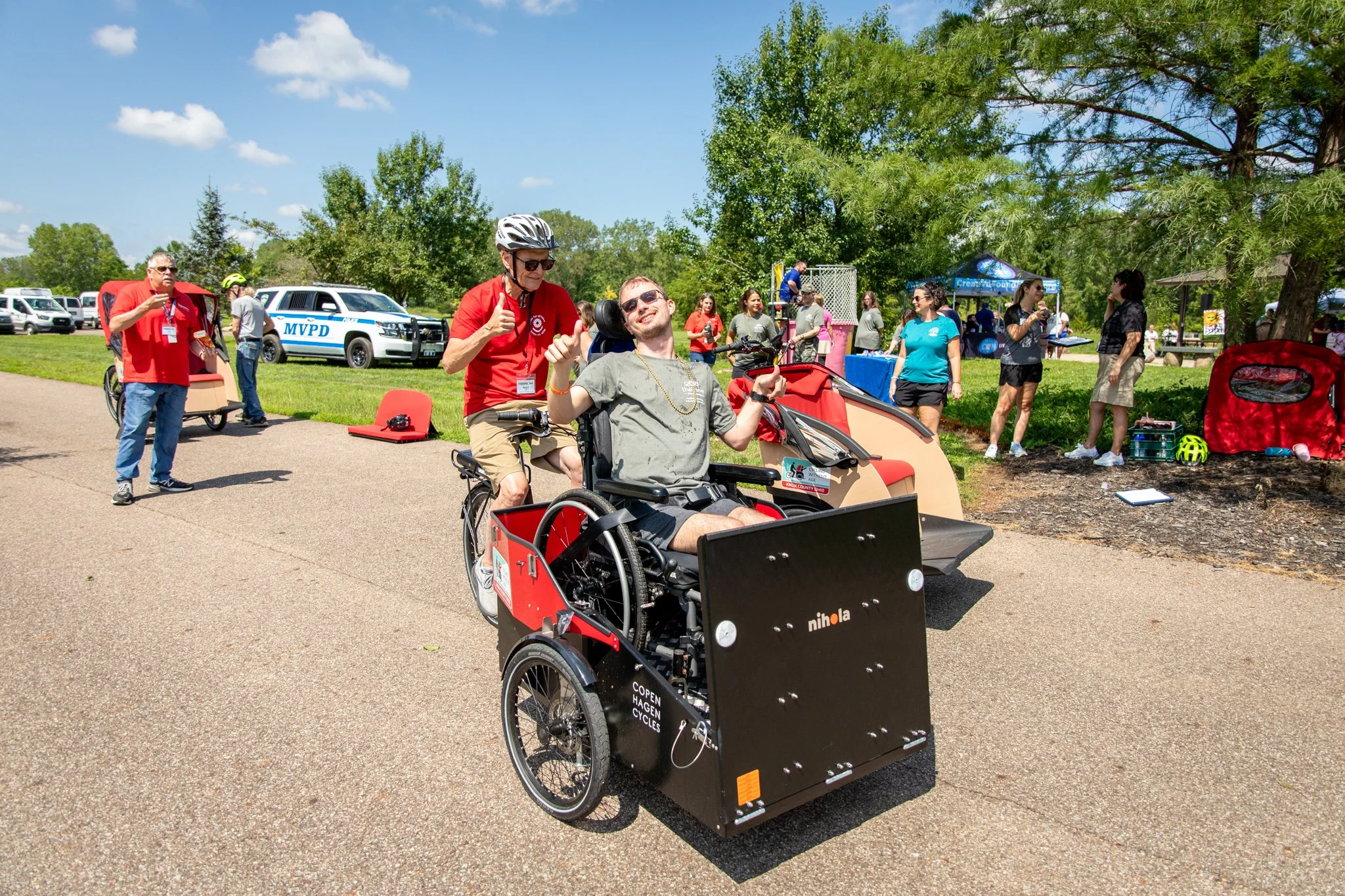 young man in wheelchair riding on a happy spokes bike