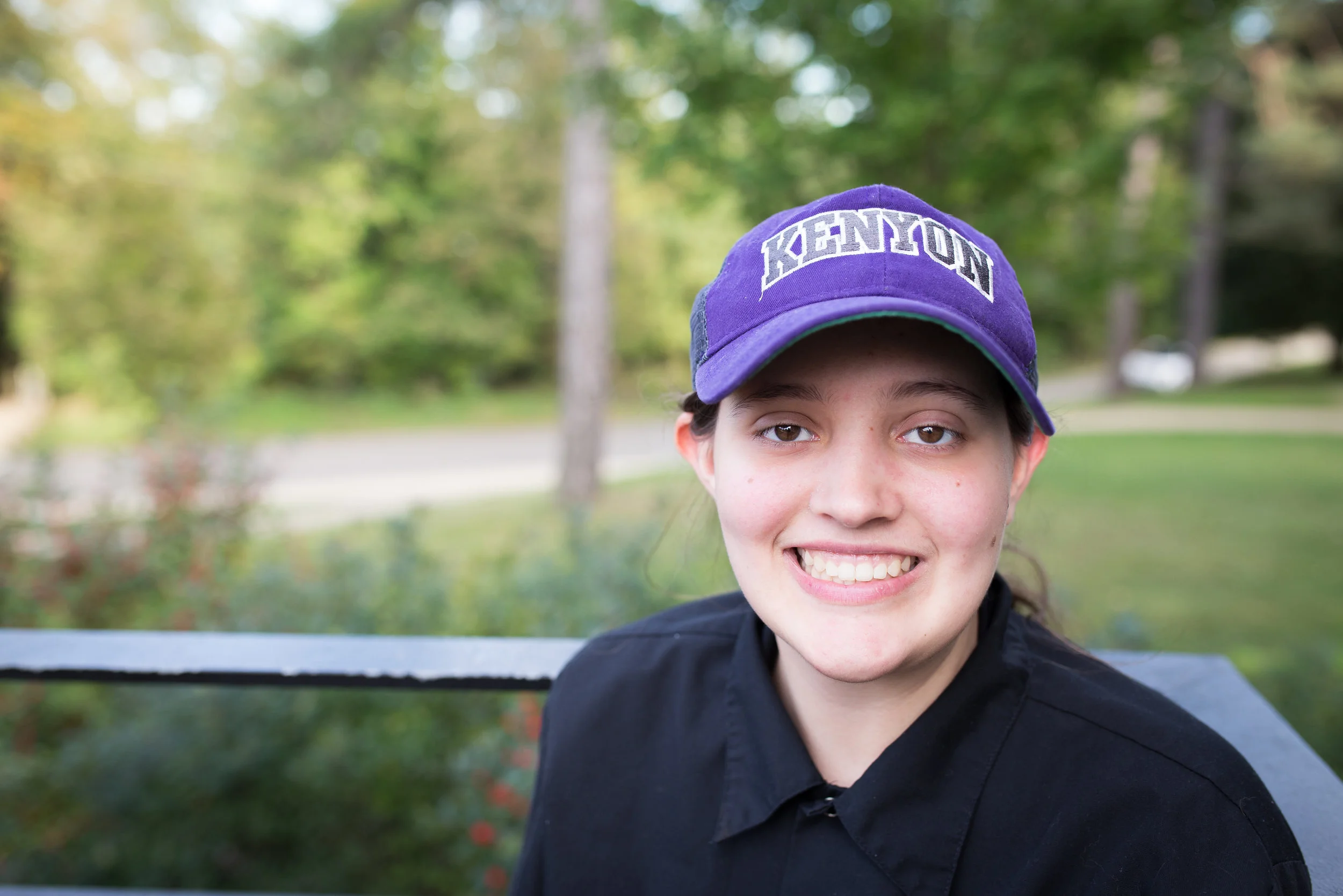 Portrait of young woman wearing work uniform smiling at camera
