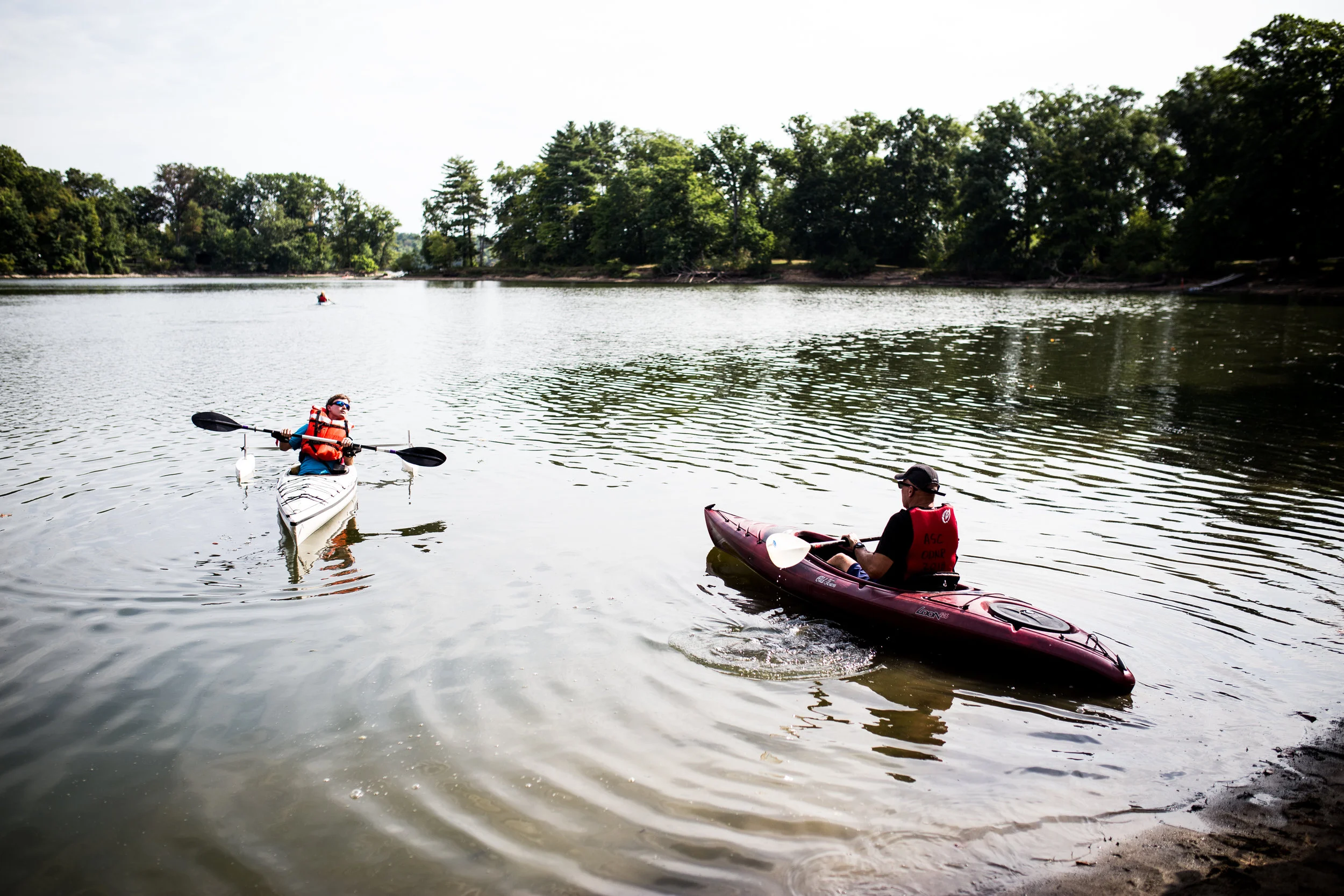 picture of young man with disability kayaking with provider