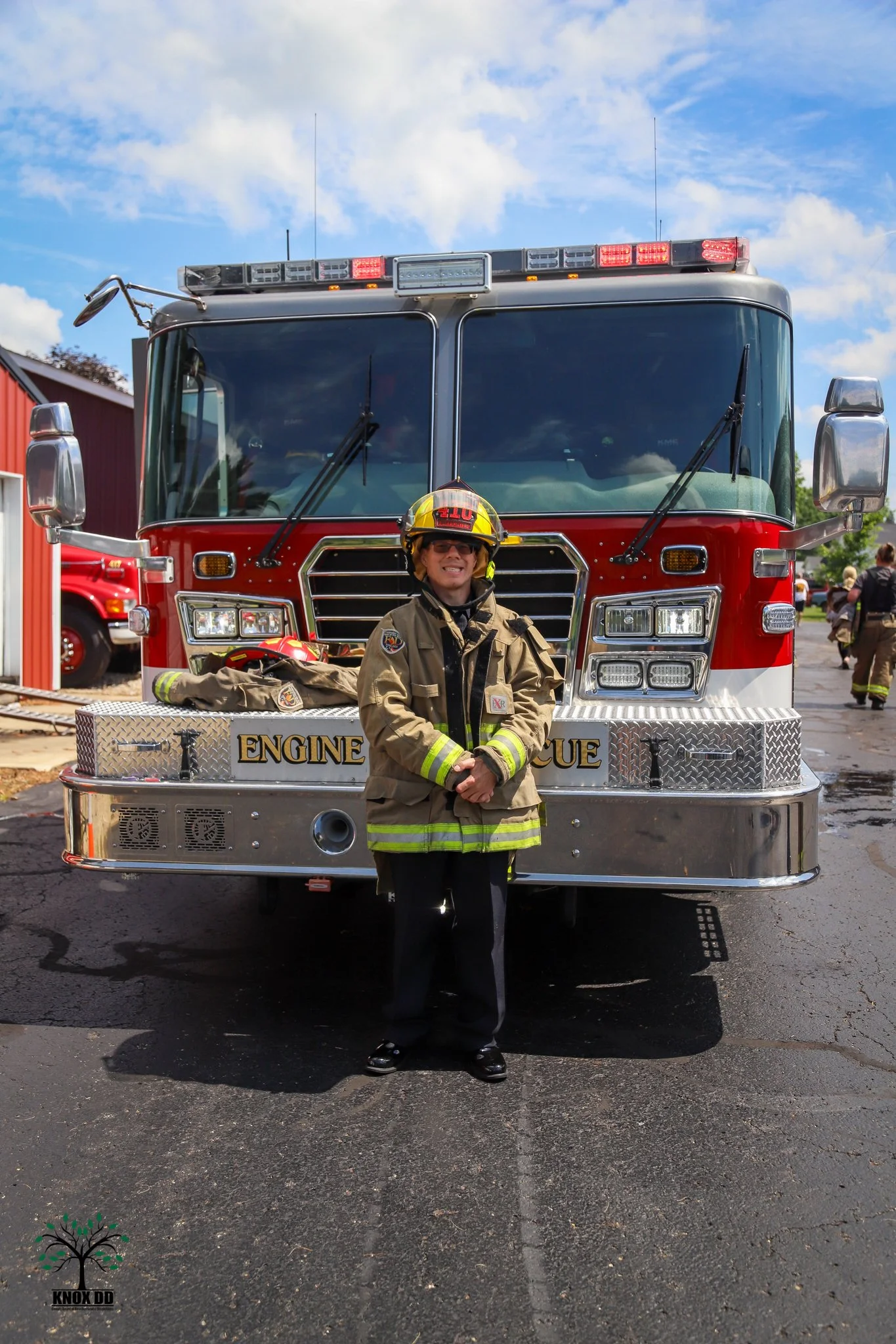 brad porter, honorary fire fighter in uniform in front of fire engine